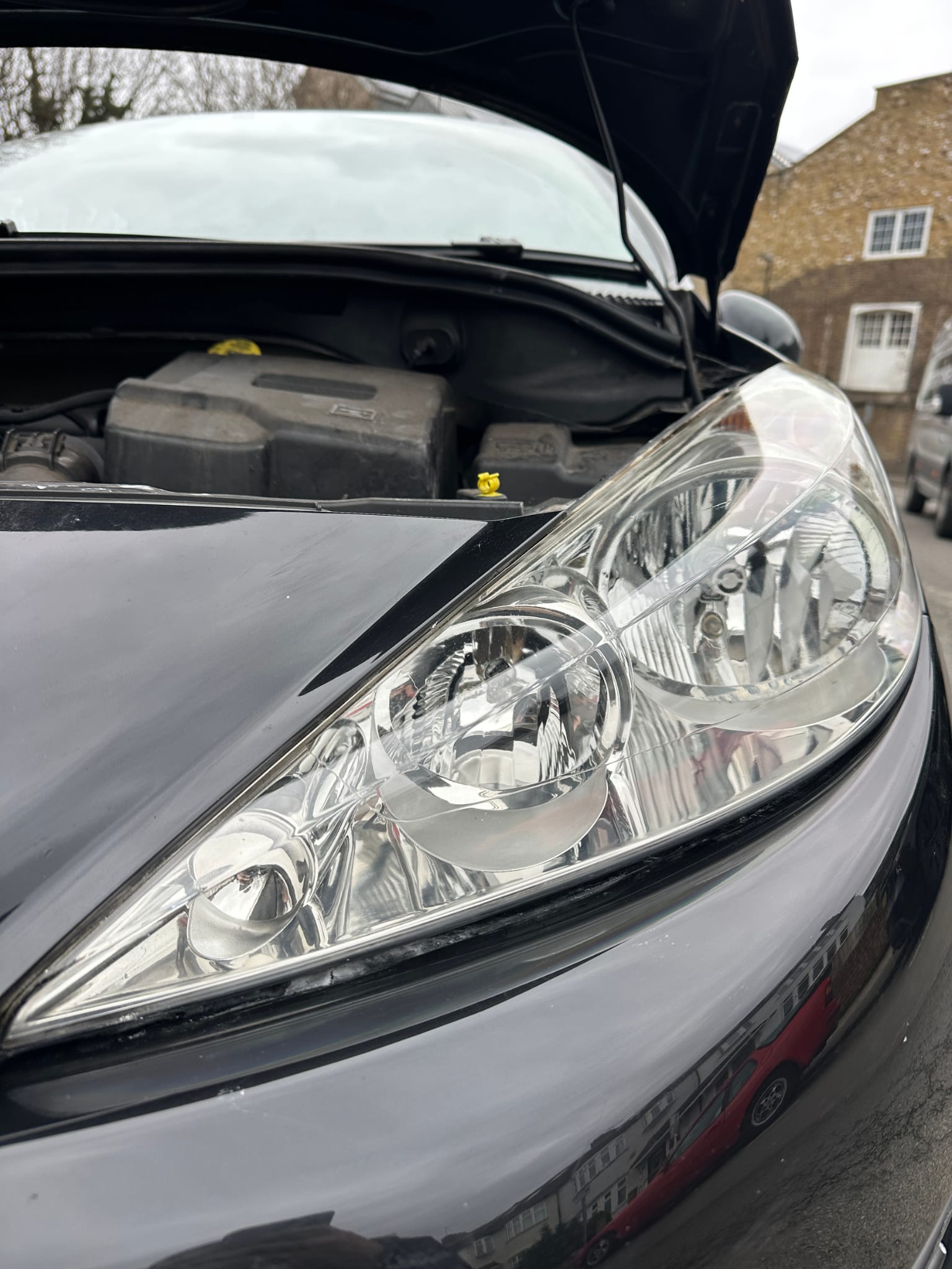 Headlight after Gold restoration — crystal clear with ceramic coating