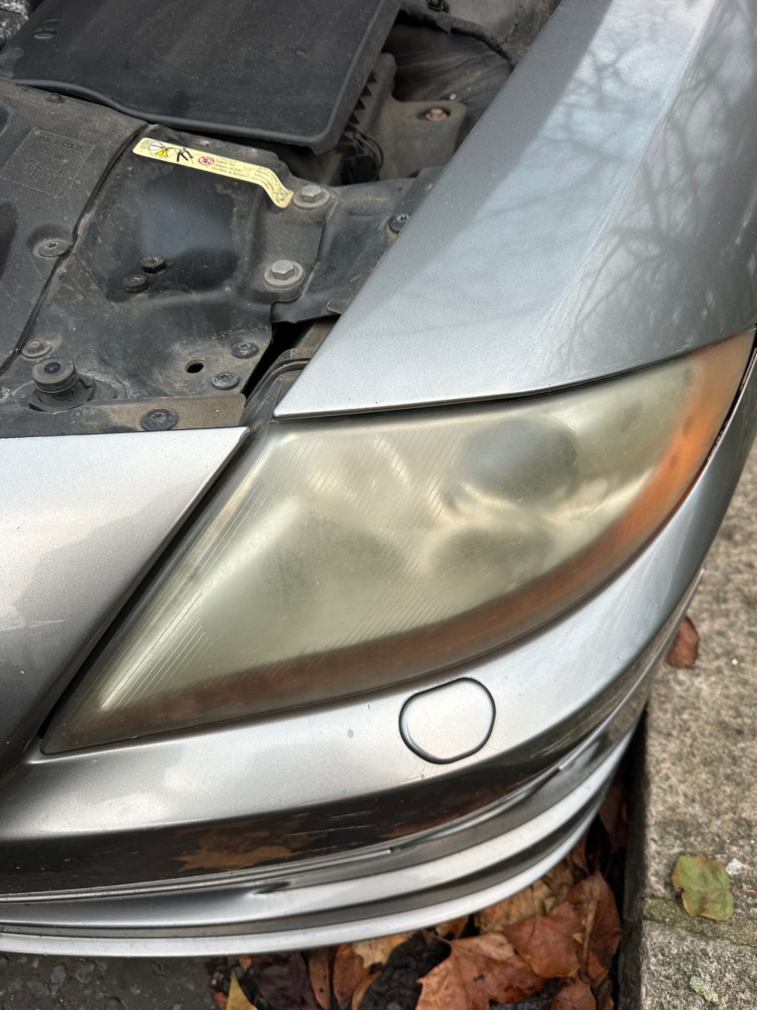 Headlight before restoration — oxidised