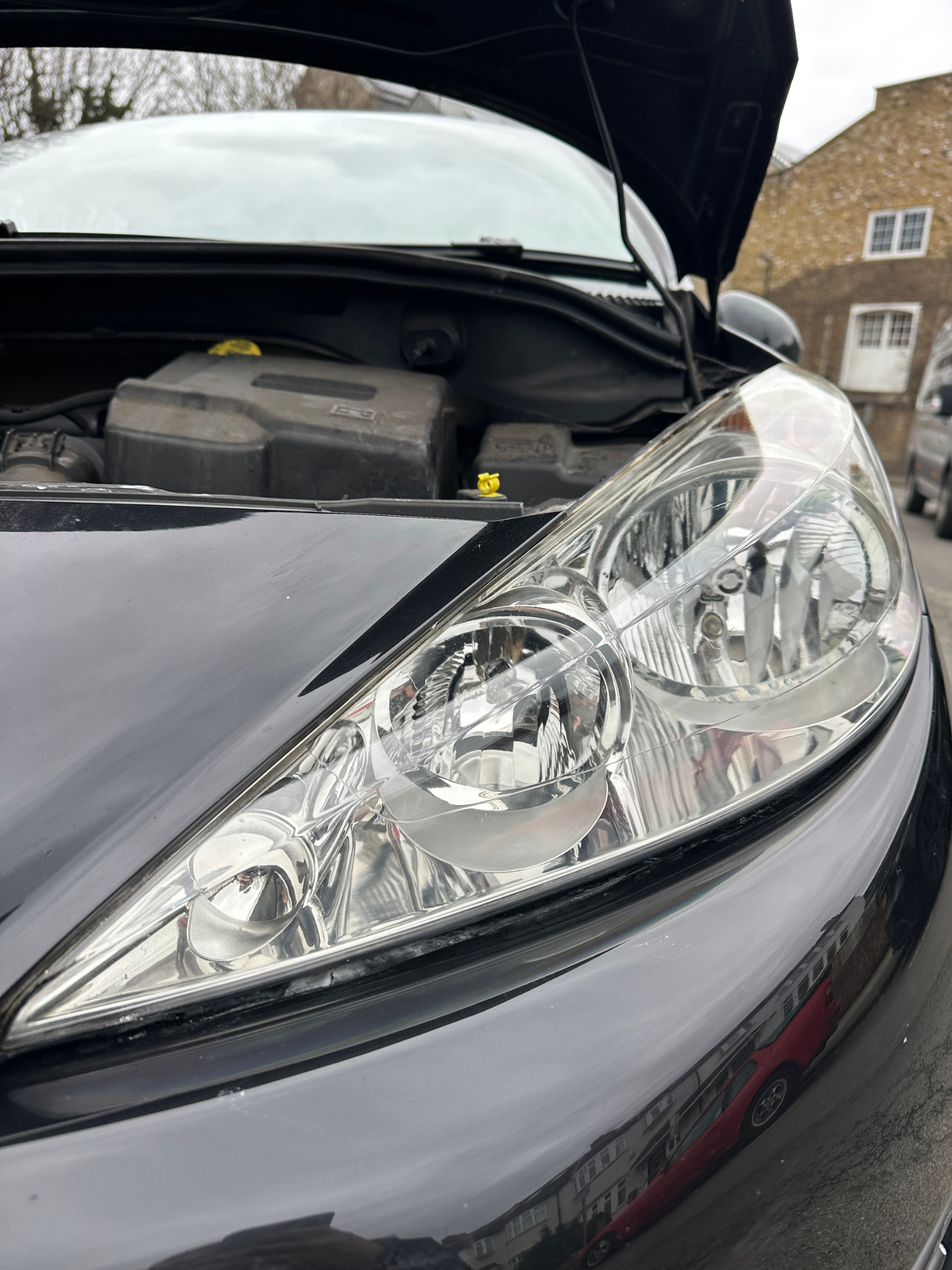 Headlight after Gold restoration — crystal clear with ceramic coating