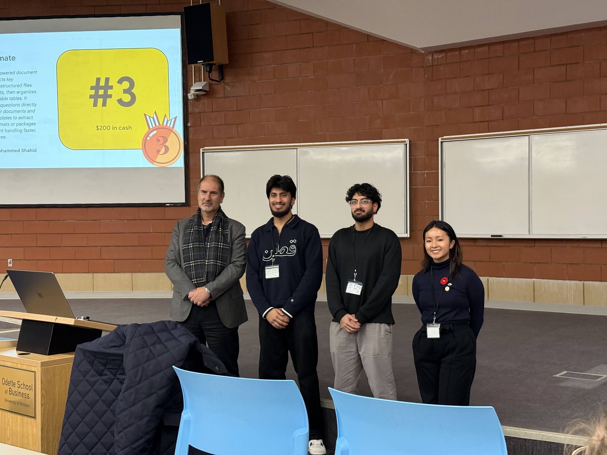 Ibrahim and Affan standing with awards at GDG Windsor DevFest 2025