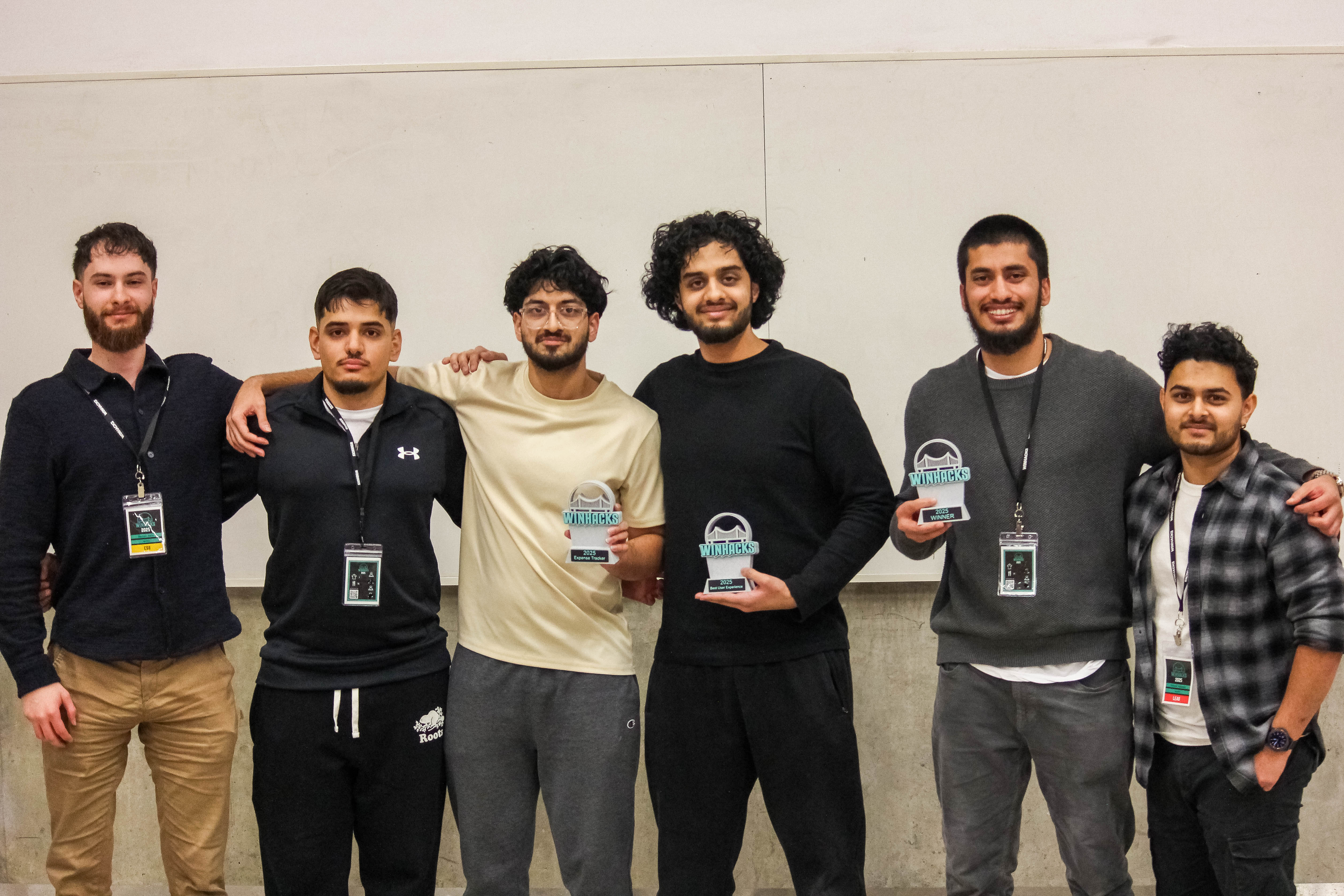 Ibrahim and Affan standing with awards at WinHacks 2025