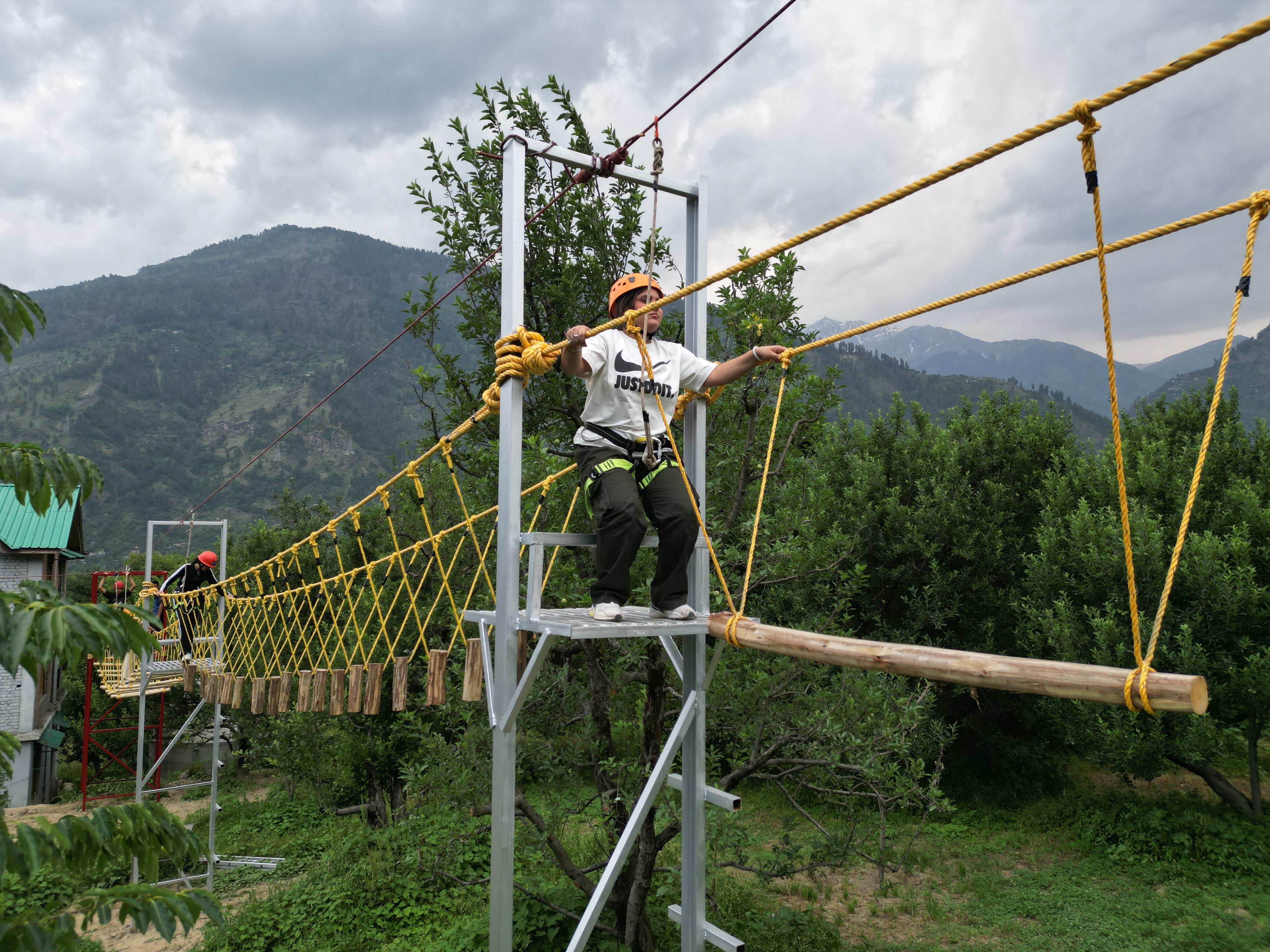 Carefully walking across a log bridge