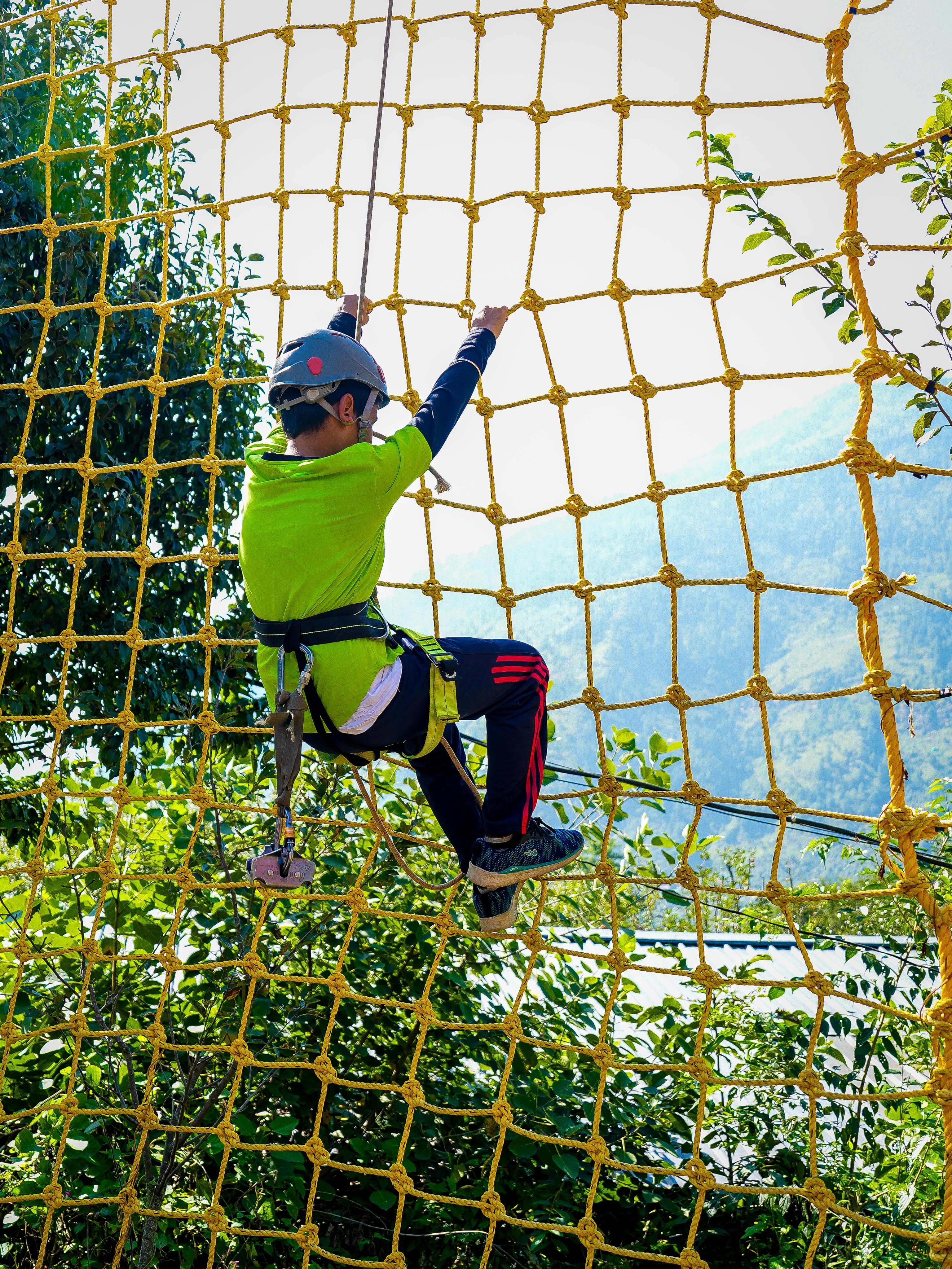 Crossing a rustic bamboo bridge over a stream