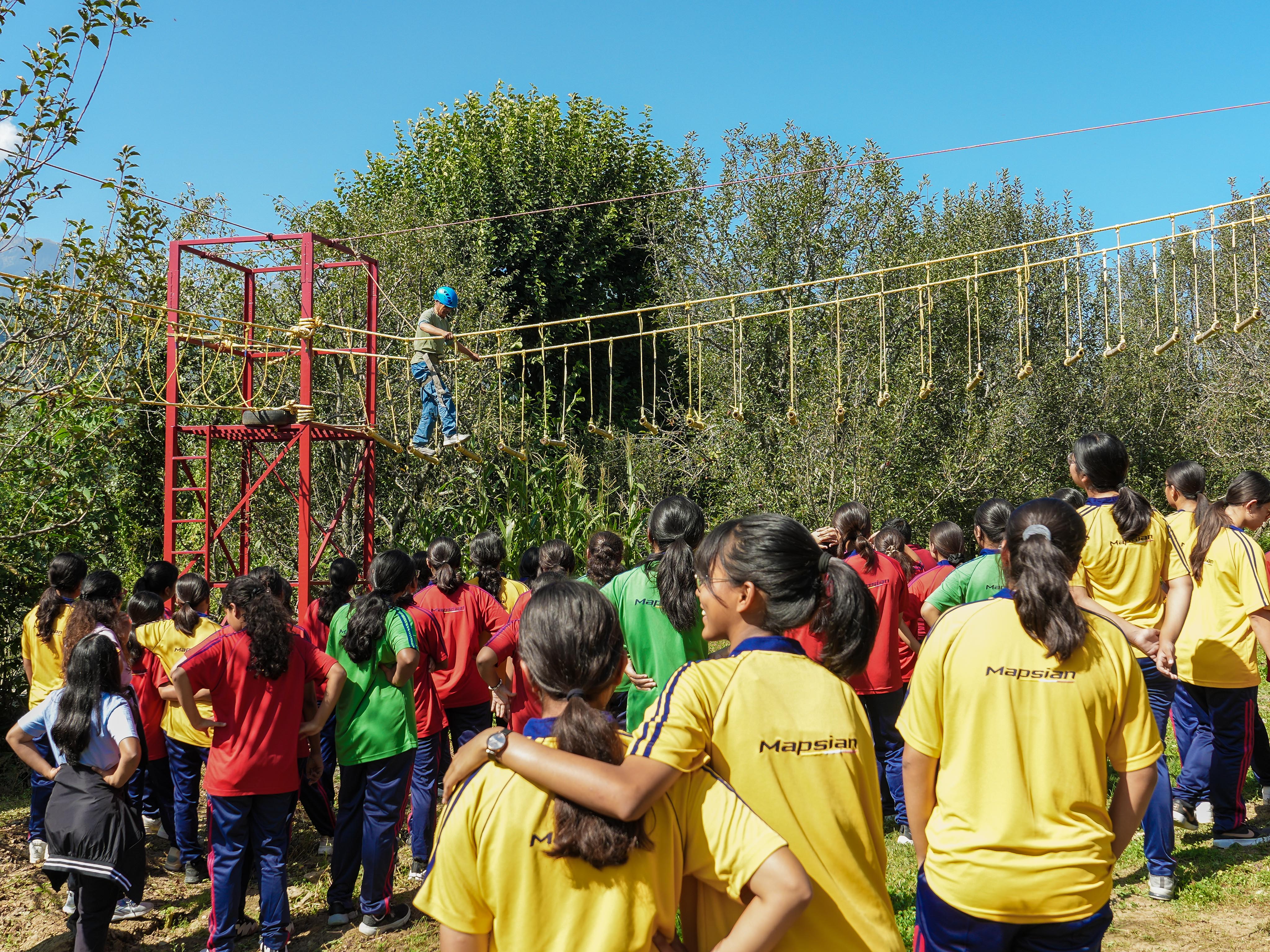 Crossing a Burma Bridge high above the ground