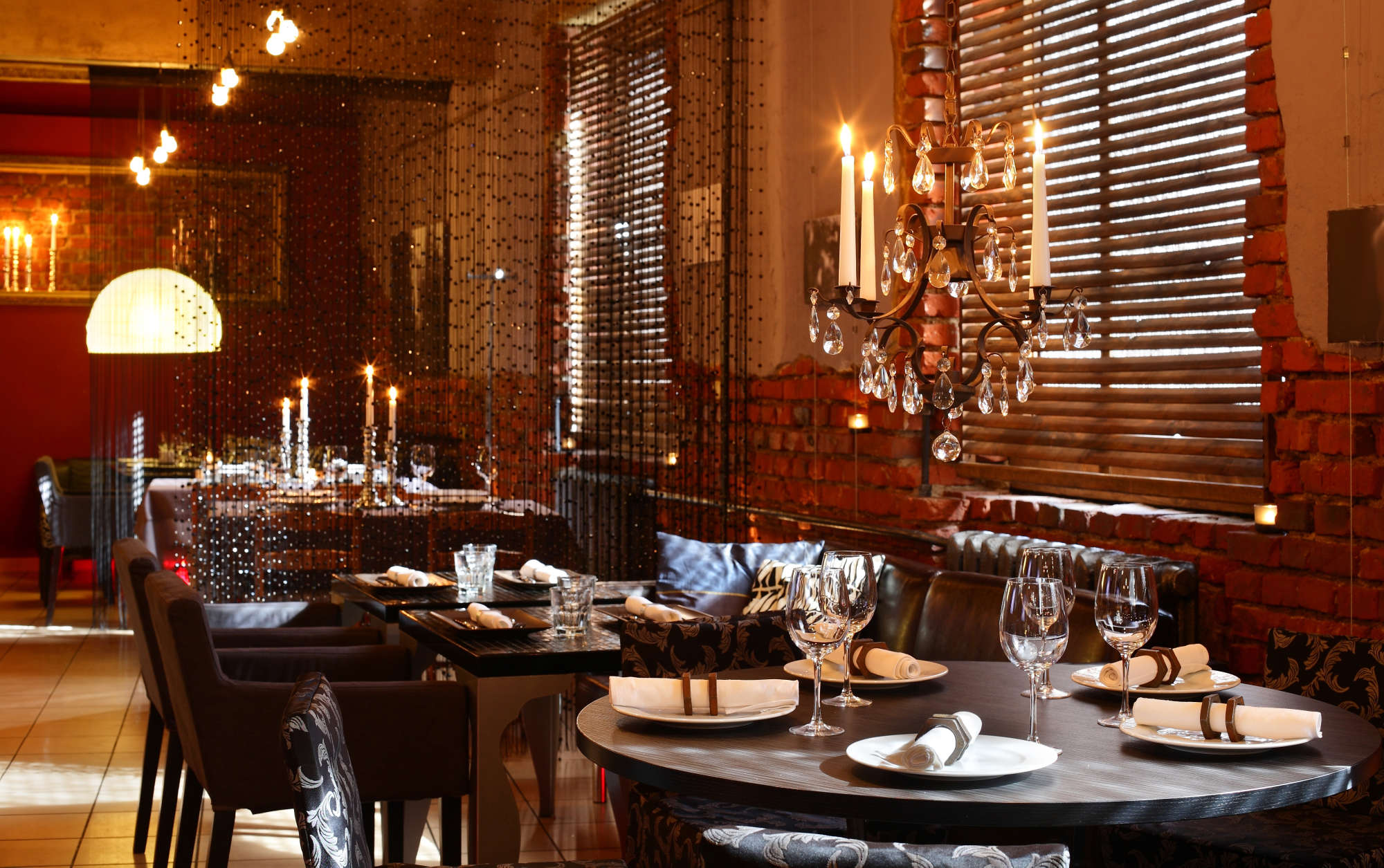The candlelit dining room and chandelier above the counter at Hanok Table