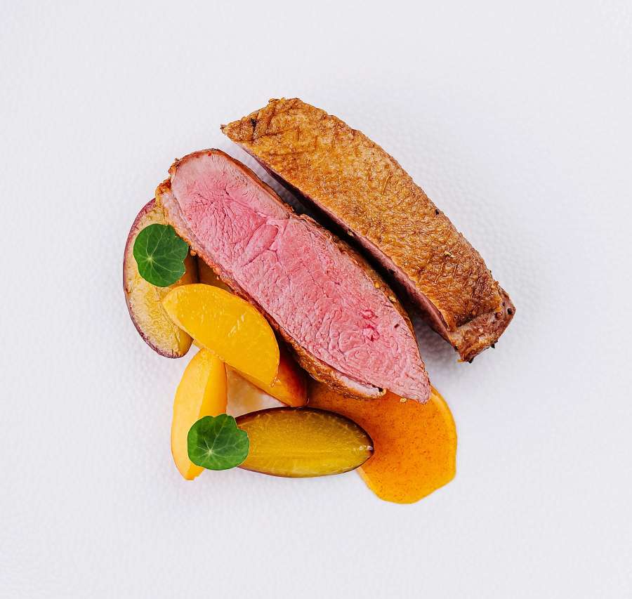A plate of slow-cooked duck with stone fruit at Hanok Table