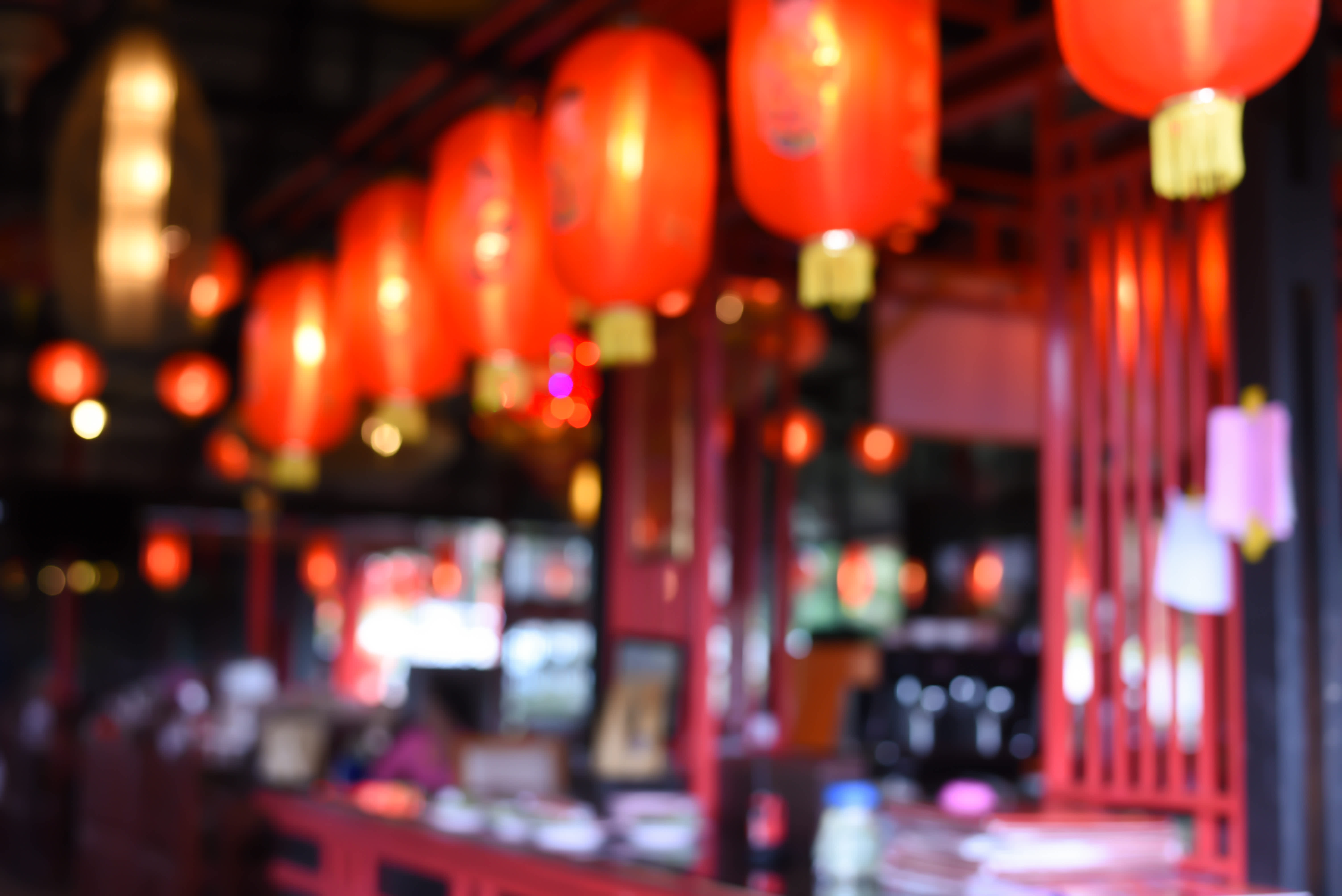 Red lanterns glowing in the night above the street