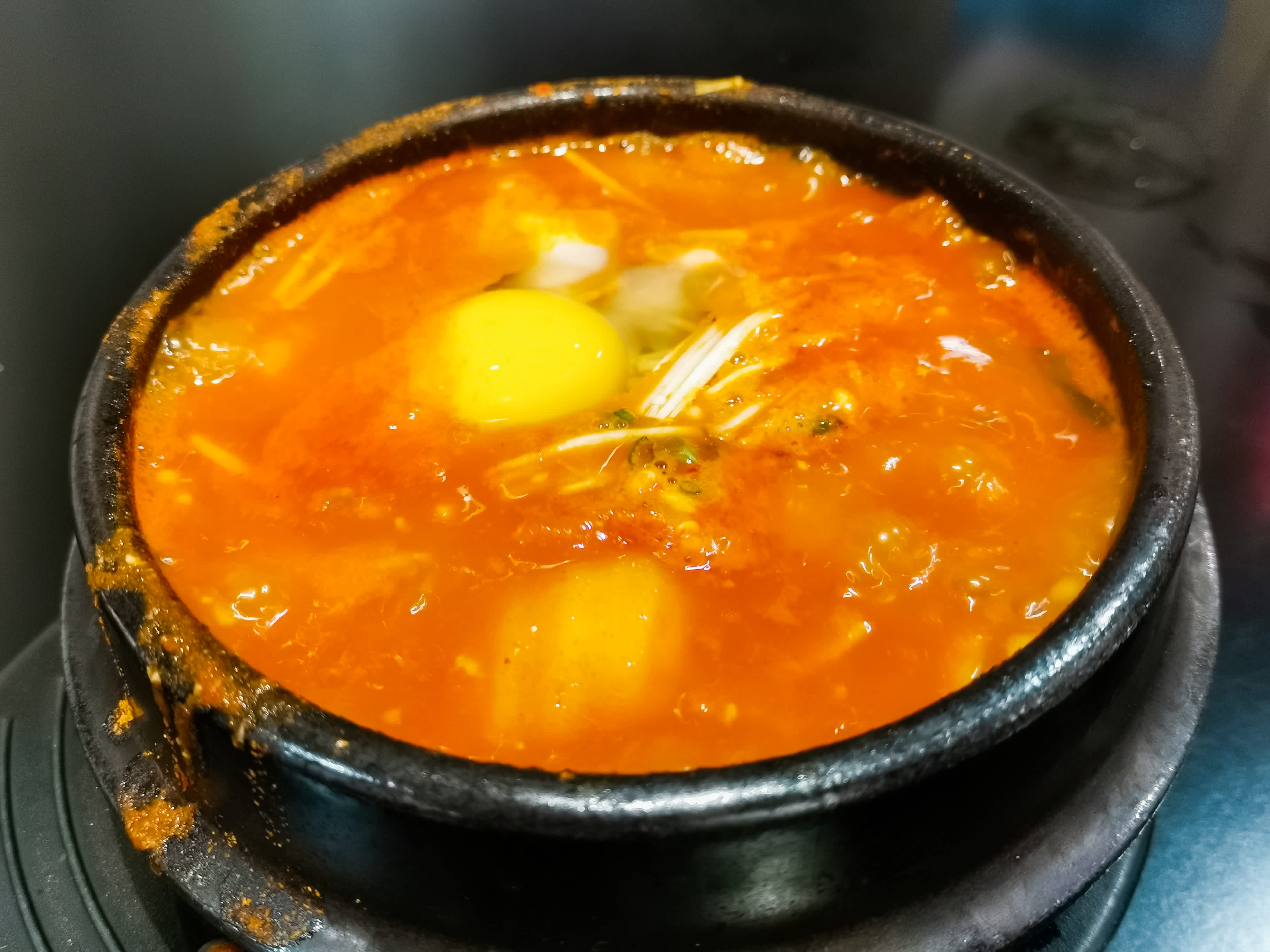 Soondubu — silken tofu stew bubbling in a stone pot
