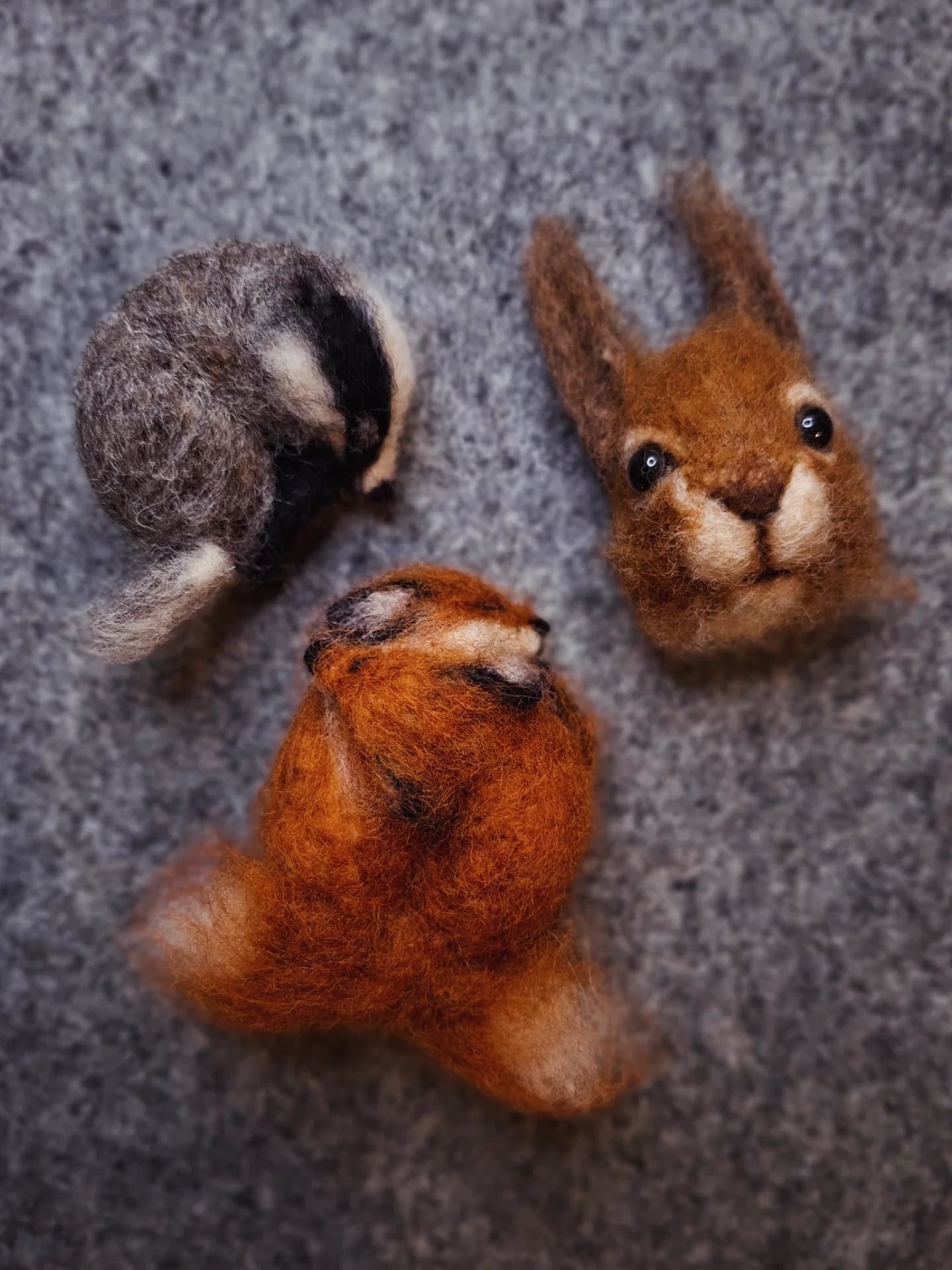 Needle felted cosy foxes brooch