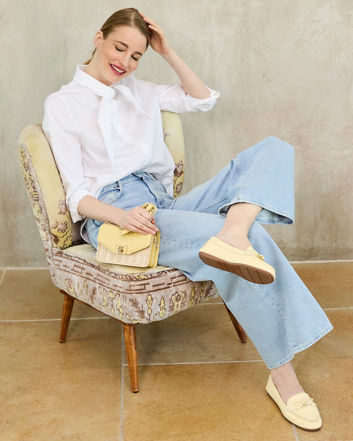 Dune London SS24 model wearing Grovers loafer and carrying Dassia bag in rattan