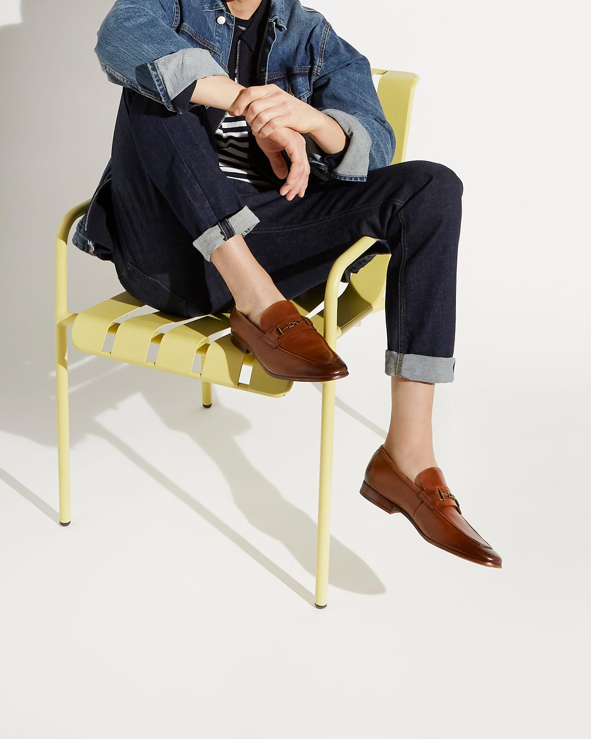 Model wearing wearing the Dune London brown men's brown Sanction loafers