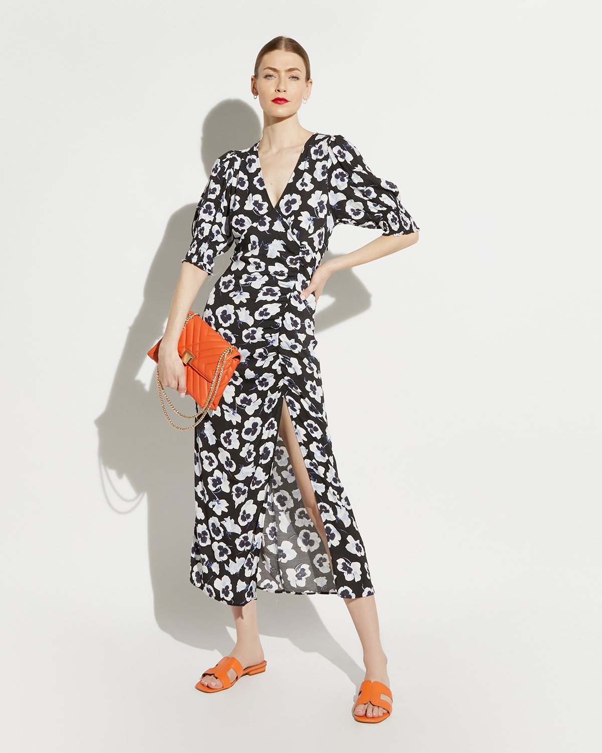 Model carrying our Dorchester bag and wearing our Dune Icon Loupe in orange