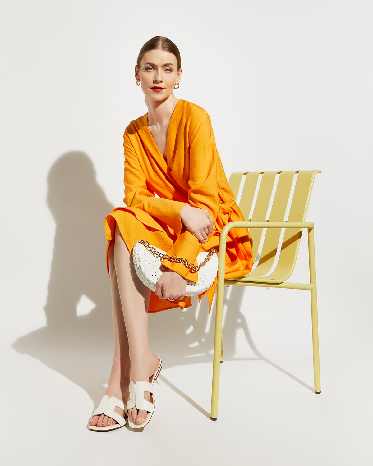 Model wearing our Dune Icon Loupe in white and carrying our Dammi bag