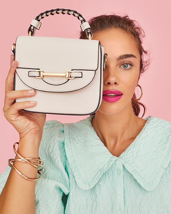 Model holding the Daydreams bag in front of her face