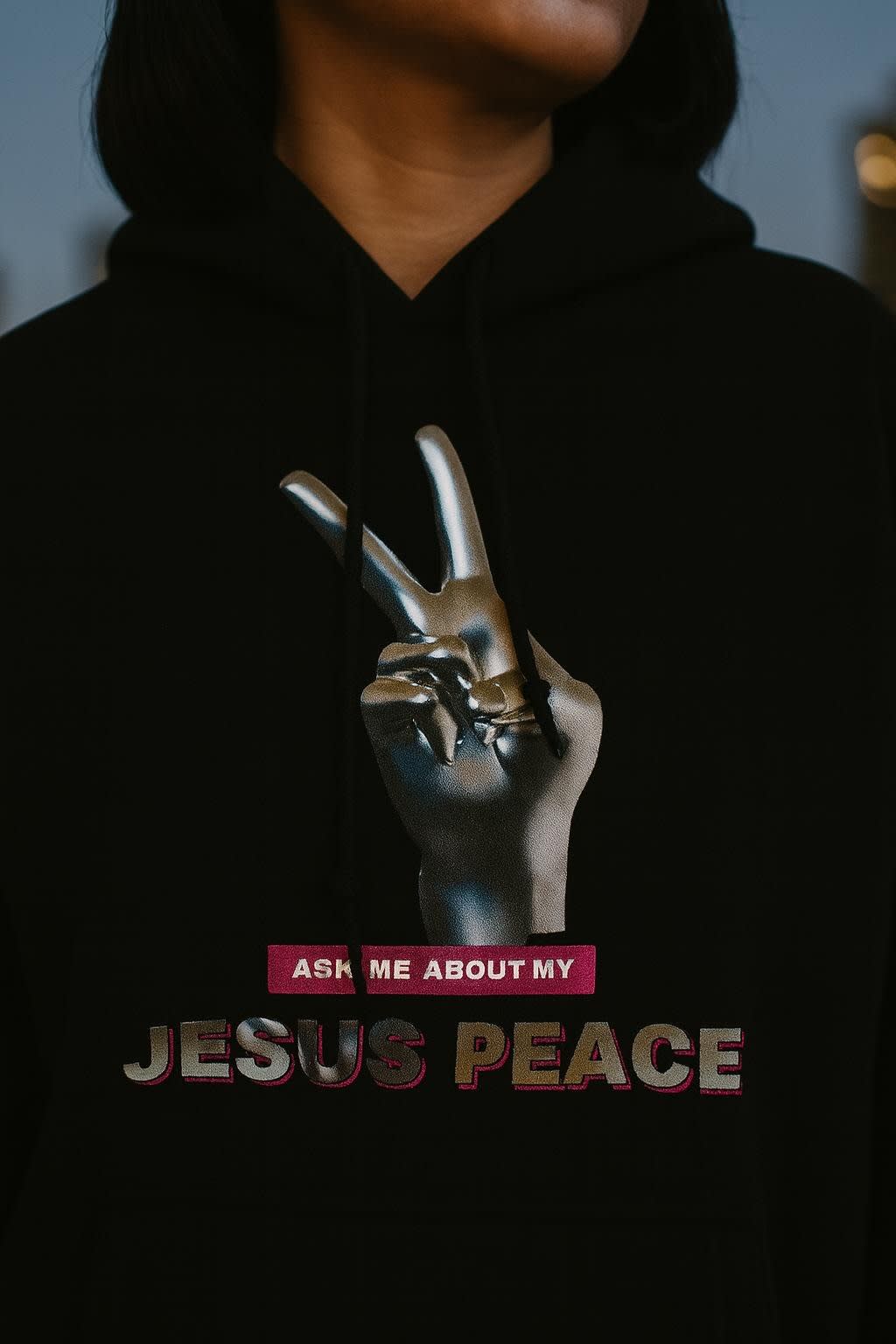 Jesus Piece worn on the college hoodie, detail view