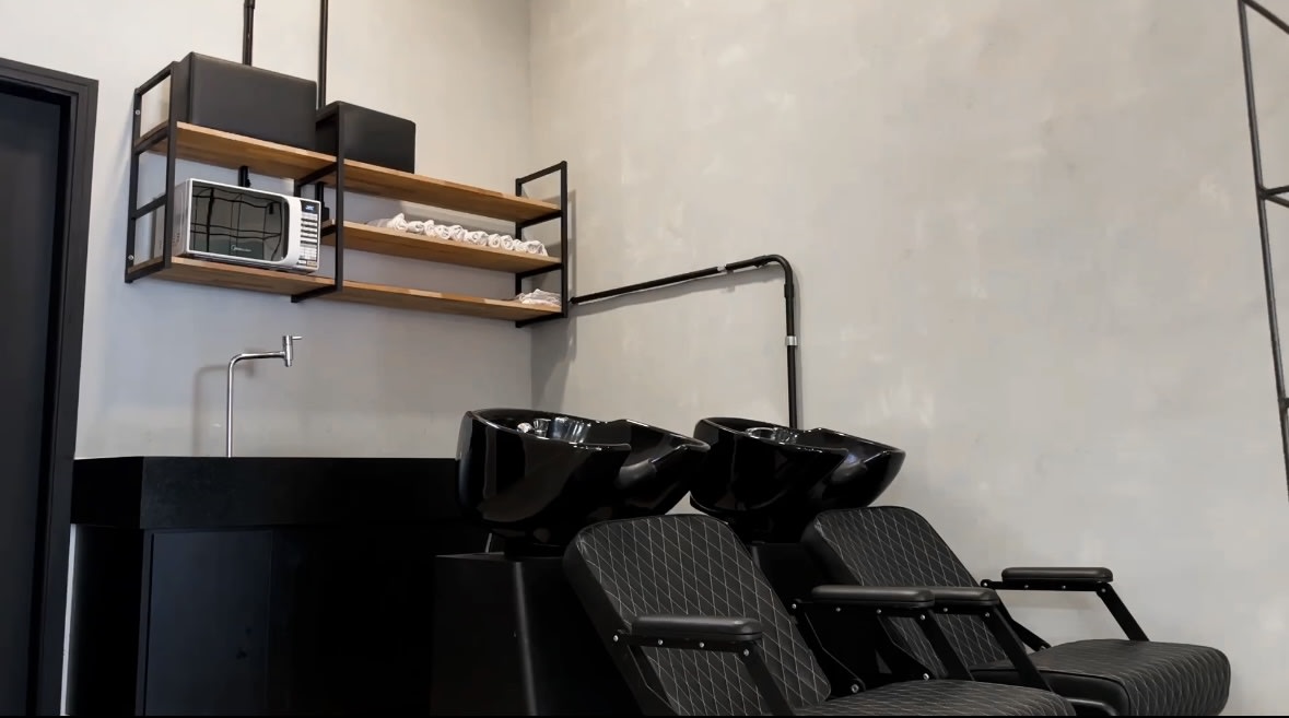 Ambiente da Barbearia Zorzin — iluminação planejada e decoração clean