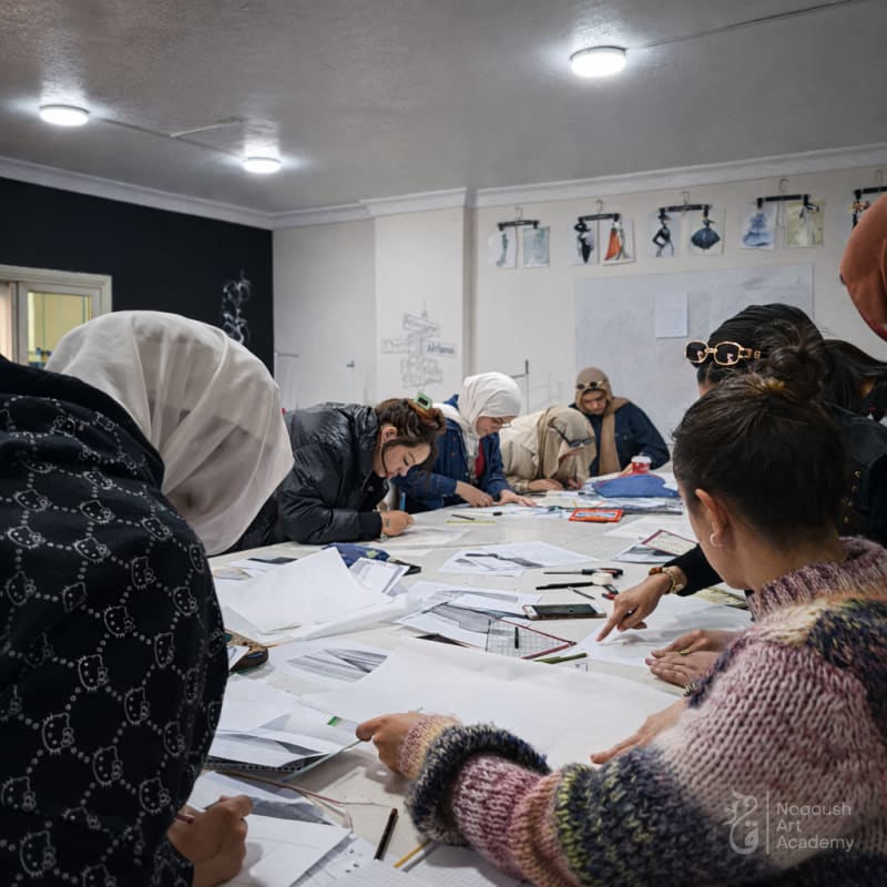 Noqoush Academy fashion workshop - students at drafting tables Cairo