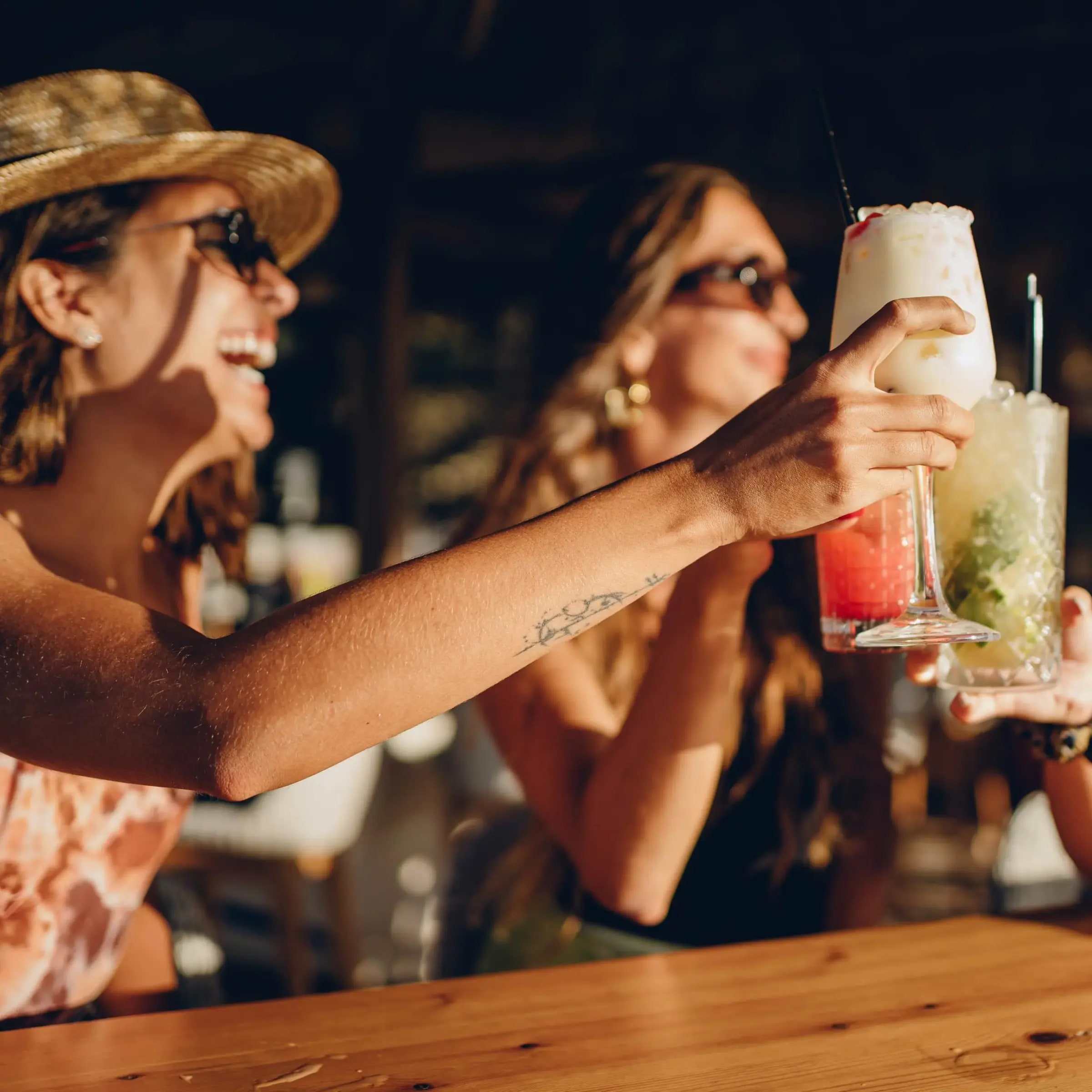 Friends clinking cocktail glasses on a night out