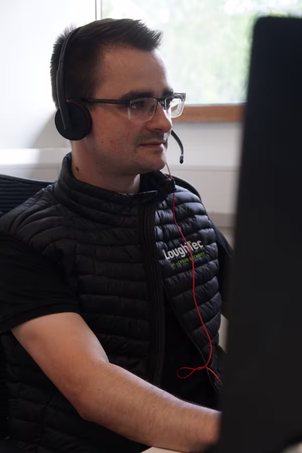 LoughTec Employee at Computer
