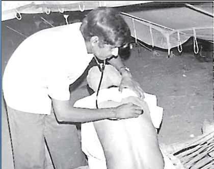 A doctor examining a patient illustrates healthcare as a tertiary activity.