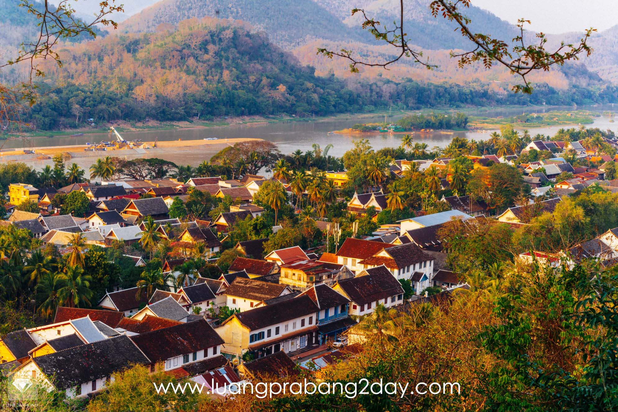 A panoramic view of Luang Prabang showing traditional houses, temples, and the Mekong River, illustrating how preserved cities can conceal complex internal systems. A panoramic view of Luang Prabang showing traditional houses, temples, and the Mekong River, illustrating how preserved cities can conceal complex internal systems.