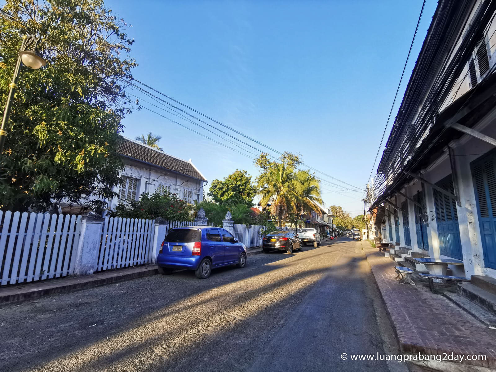 Quiet historic street in Luang Prabang showing preserved architecture and orderly urban space without visible daily activity Quiet historic street in Luang Prabang showing preserved architecture and orderly urban space without visible daily activity
