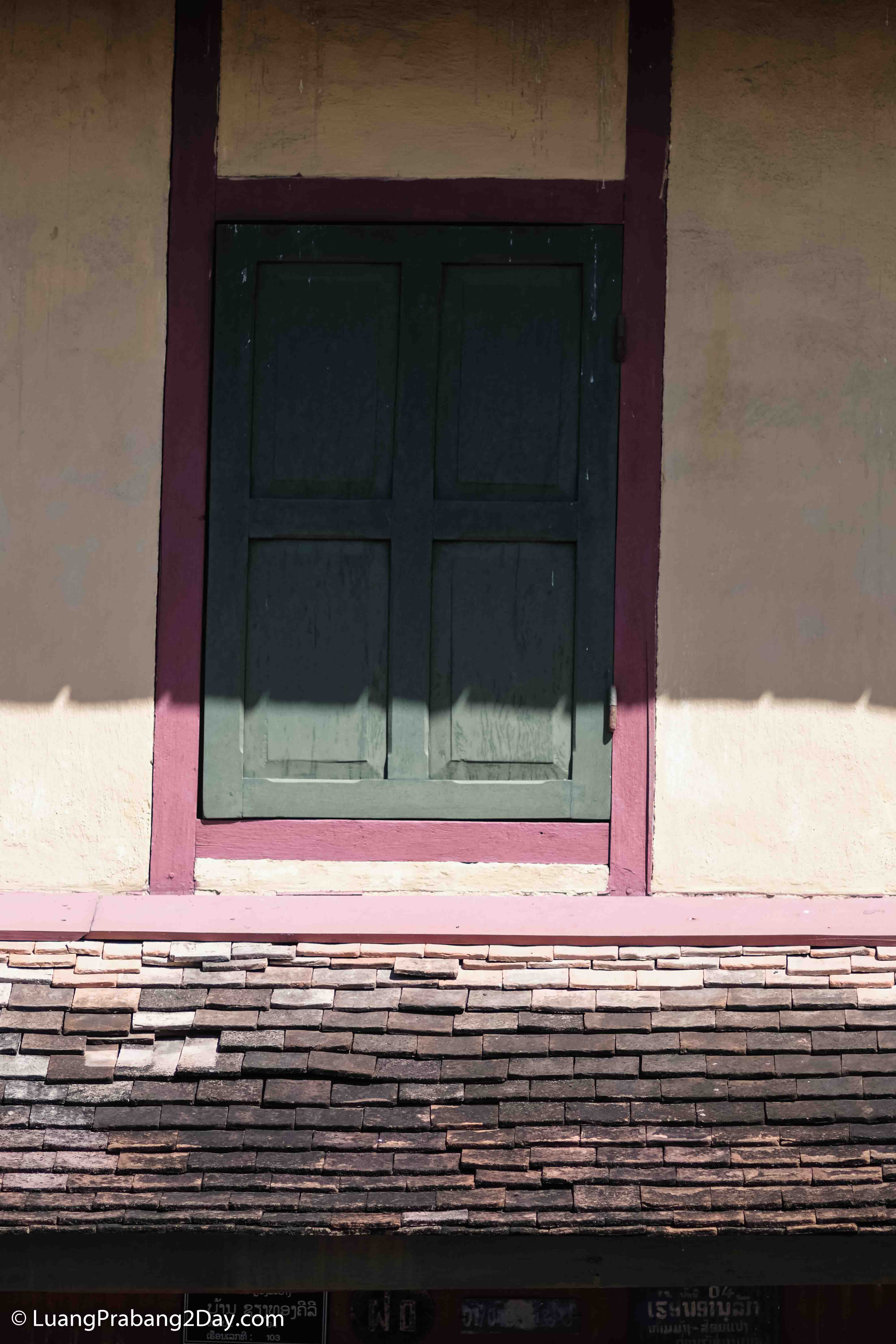 An aged doorway of a traditional Lao timber house, reflecting the quiet passage of time and craftsmanship. An aged doorway of a traditional Lao timber house, reflecting the quiet passage of time and craftsmanship.