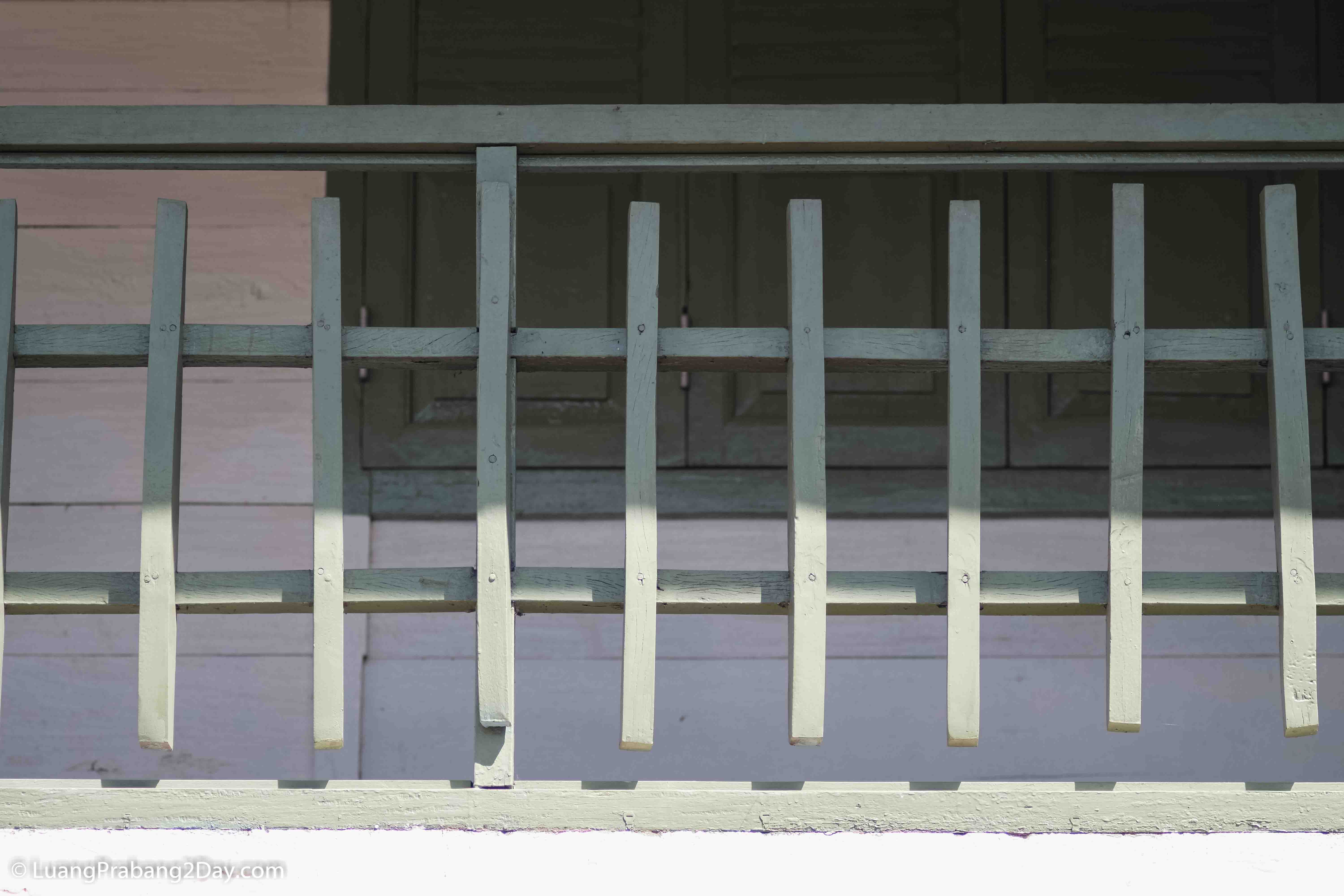 Simple wooden balcony rail demonstrating the balanced proportions of traditional Lao residential architecture. Simple wooden balcony rail demonstrating the balanced proportions of traditional Lao residential architecture.
