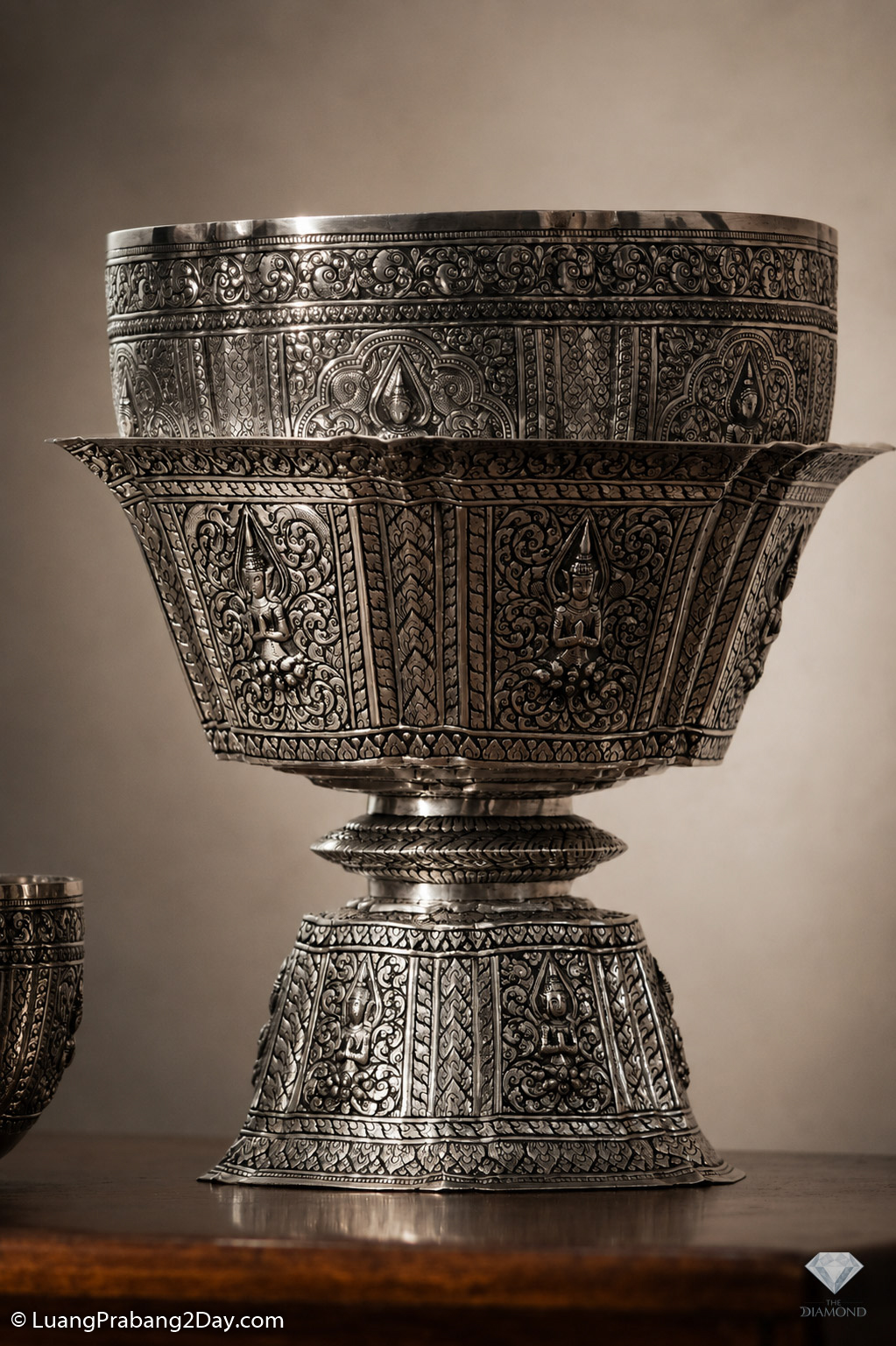 An elaborately engraved ceremonial silver offering bowl handcrafted by the Phothisak Rattanakorn family in Luang Prabang. An elaborately engraved ceremonial silver offering bowl handcrafted by the Phothisak Rattanakorn family in Luang Prabang.
