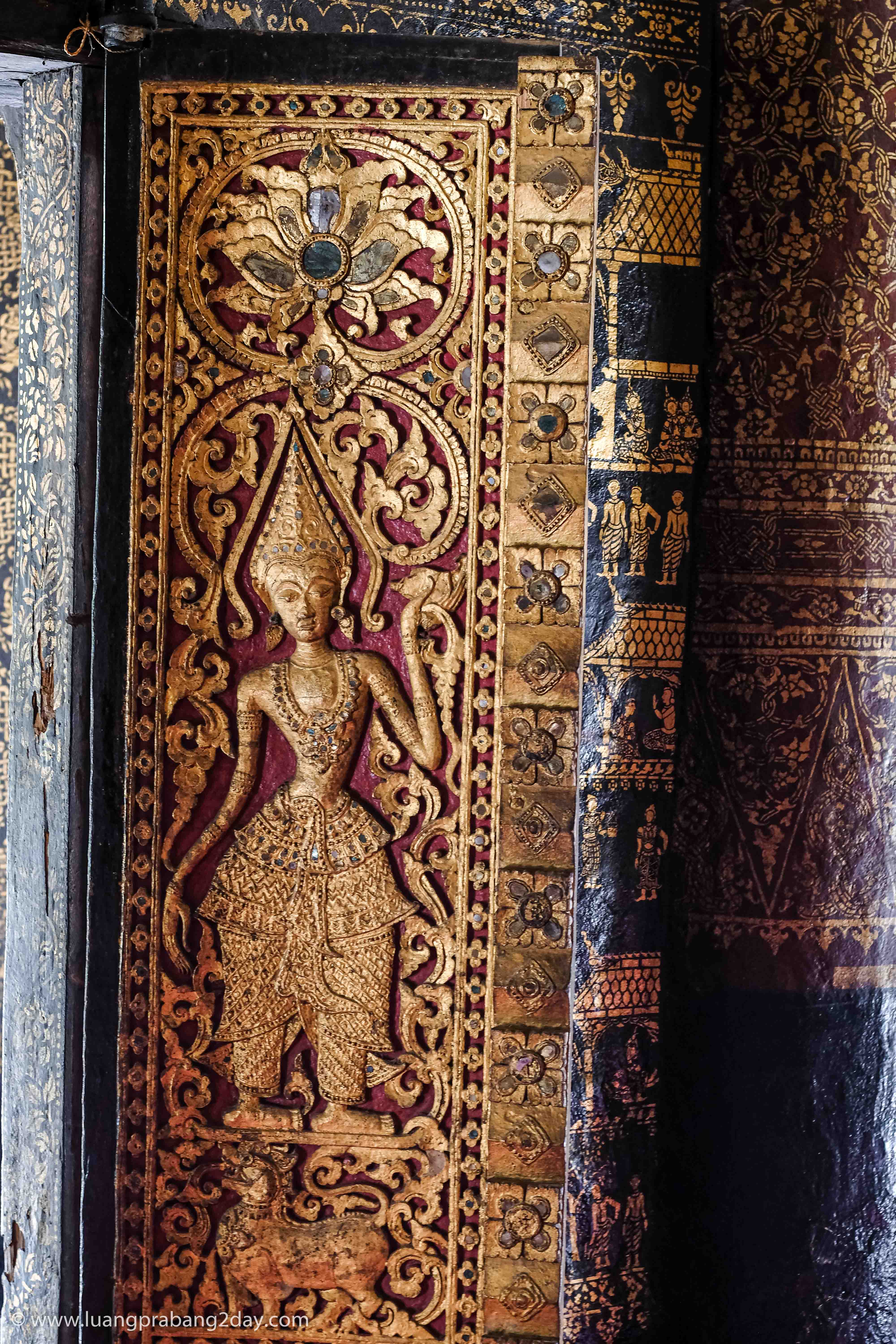 Hand-carved gilded wooden pillar showcasing traditional Lao decorative craftsmanship at Wat Xieng Thong. Hand-carved gilded wooden pillar showcasing traditional Lao decorative craftsmanship at Wat Xieng Thong.