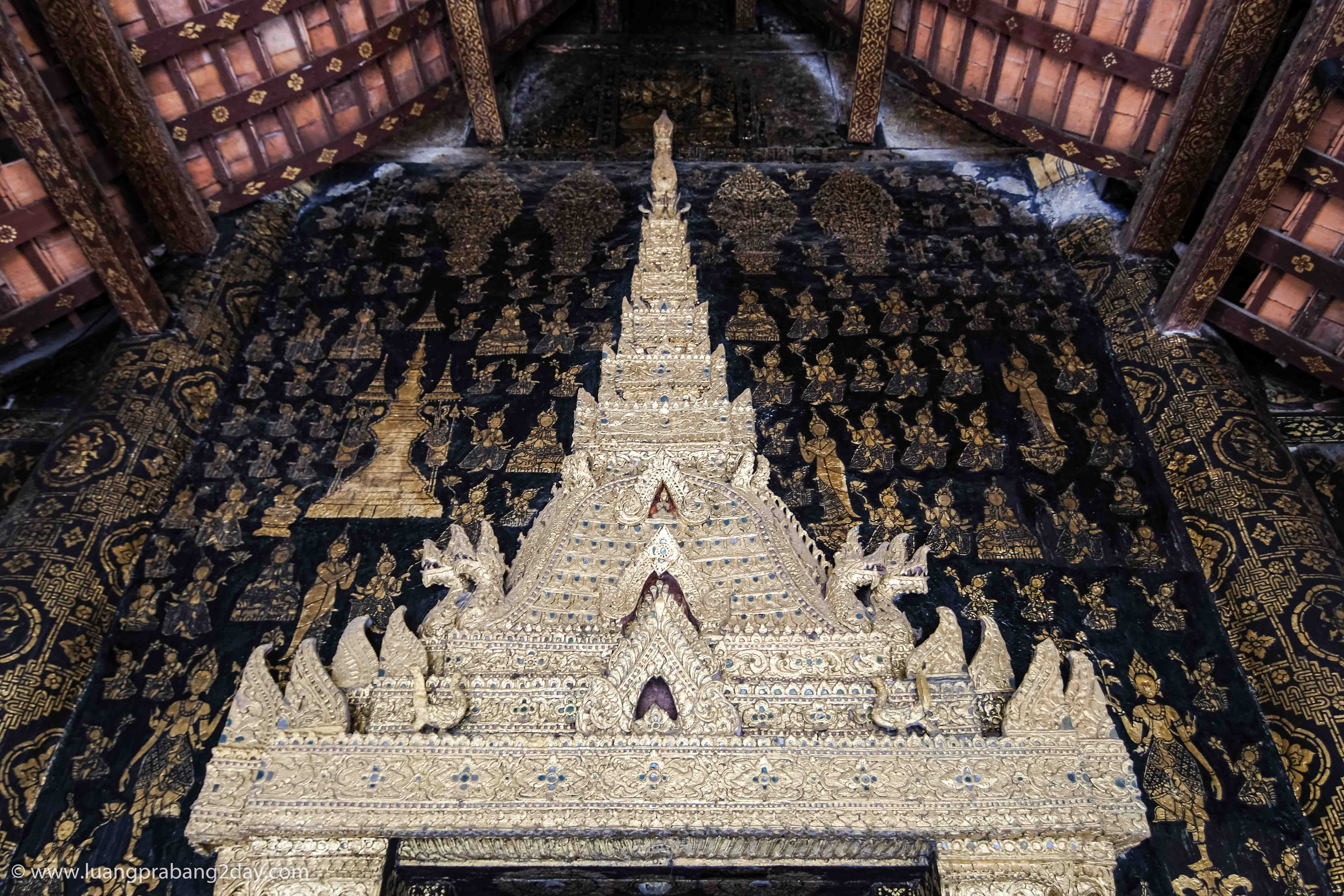Decorated doorway leading toward the principal Buddha image inside Wat Xieng Thong. Decorated doorway leading toward the principal Buddha image inside Wat Xieng Thong.