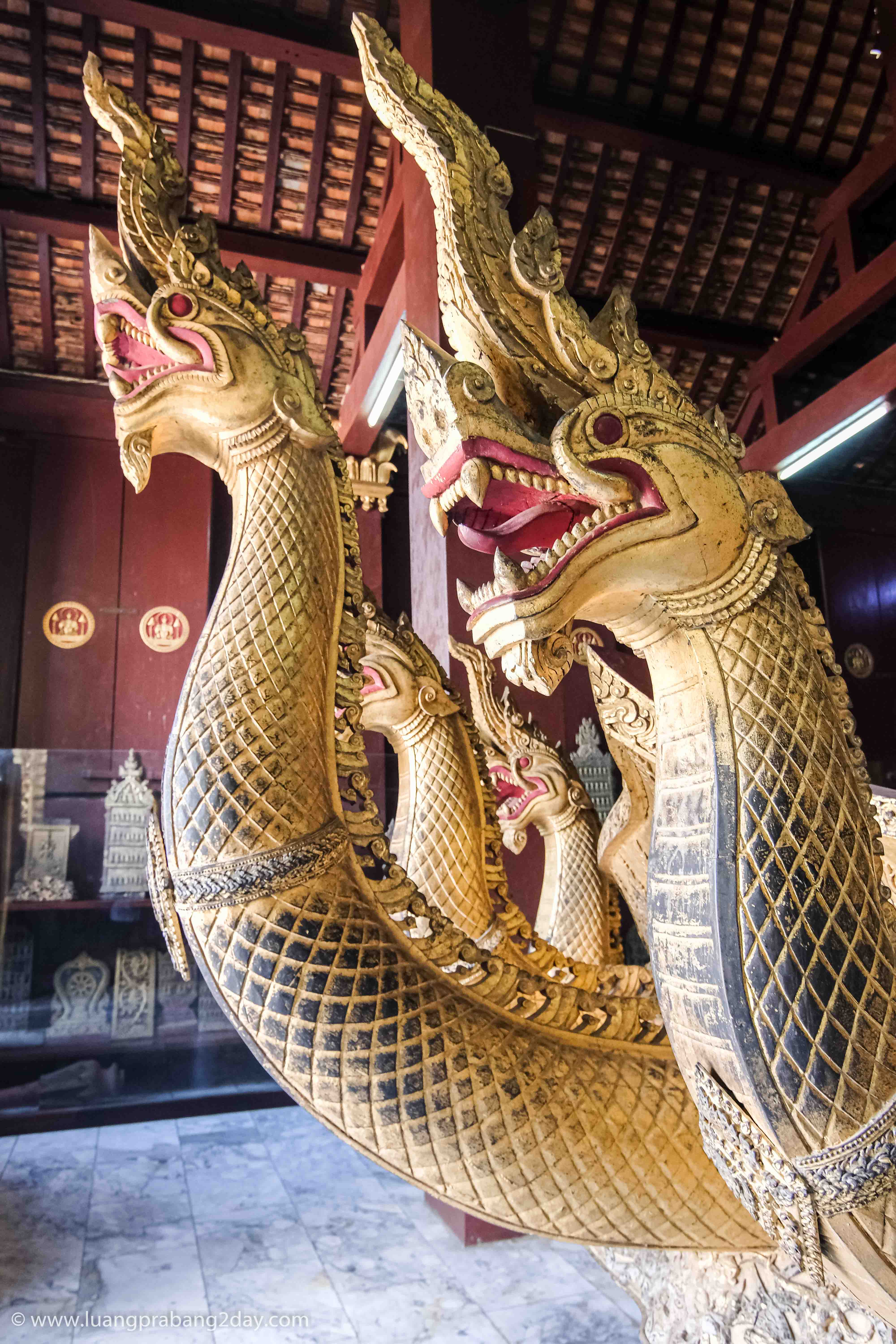 Golden naga sculpture inside Wat Xieng Thong symbolizing protection in Lao Buddhist tradition. Golden naga sculpture inside Wat Xieng Thong symbolizing protection in Lao Buddhist tradition.