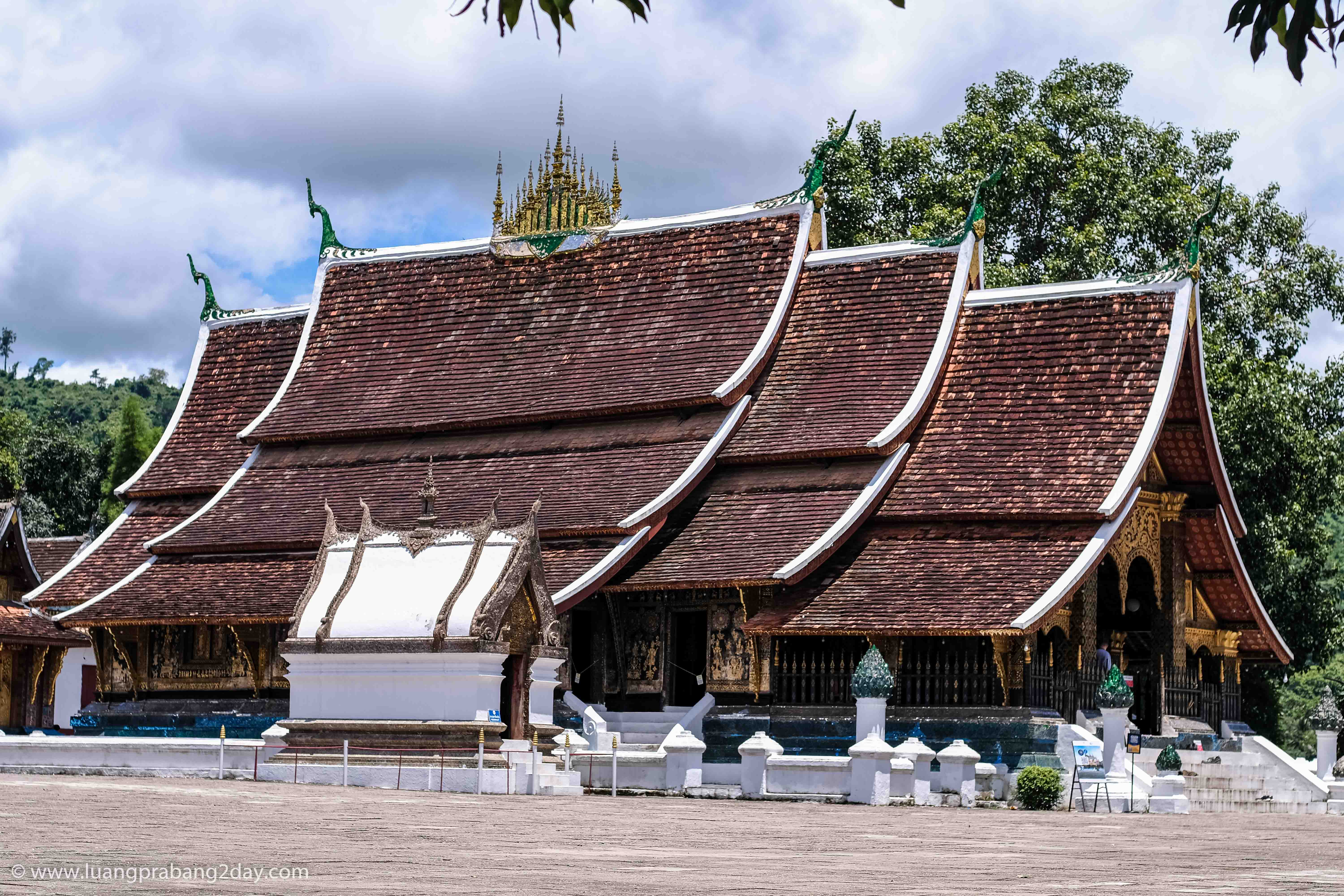 Panoramic view of Wat Xieng Thong showcasing its sweeping multi-tiered roofs and classical Lao temple architecture in Luang Prabang, Laos. Panoramic view of Wat Xieng Thong showcasing its sweeping multi-tiered roofs and classical Lao temple architecture in Luang Prabang, Laos.