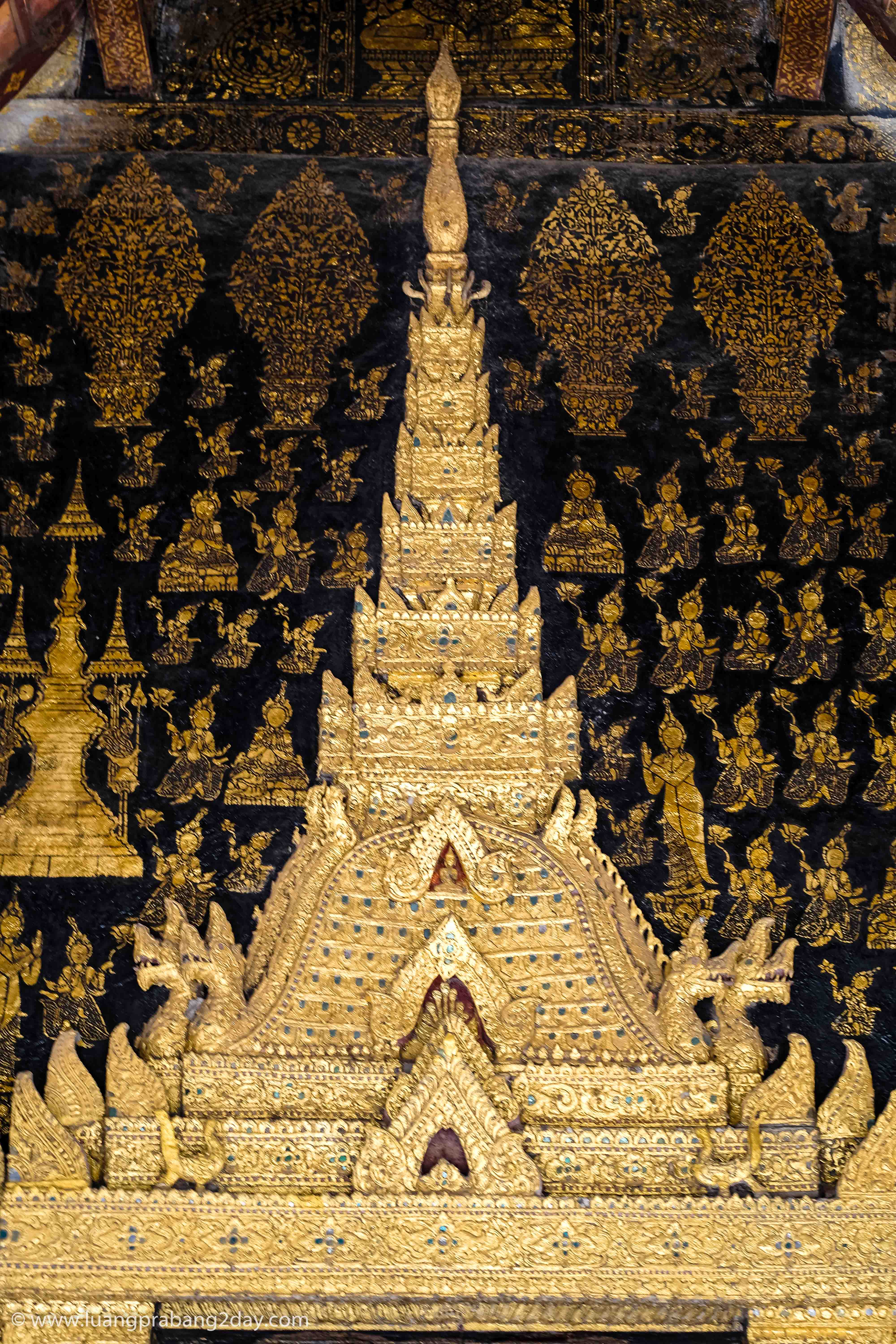 Gilded temple relief depicting traditional Lao architectural motifs at Wat Xieng Thong. Gilded temple relief depicting traditional Lao architectural motifs at Wat Xieng Thong.