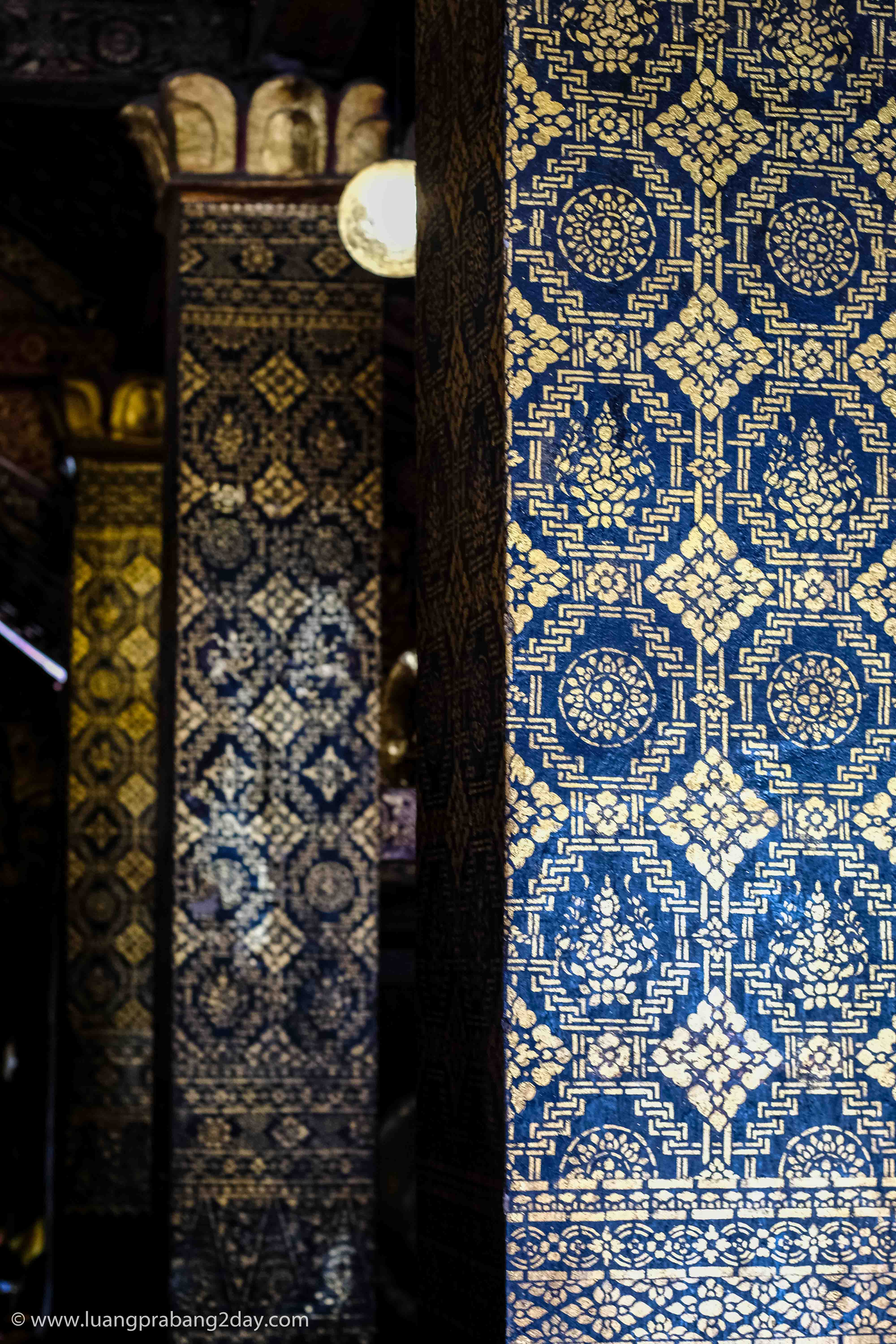 Decorative wall panel featuring repeating geometric stenciled patterns inside Wat Xieng Thong. Decorative wall panel featuring repeating geometric stenciled patterns inside Wat Xieng Thong.