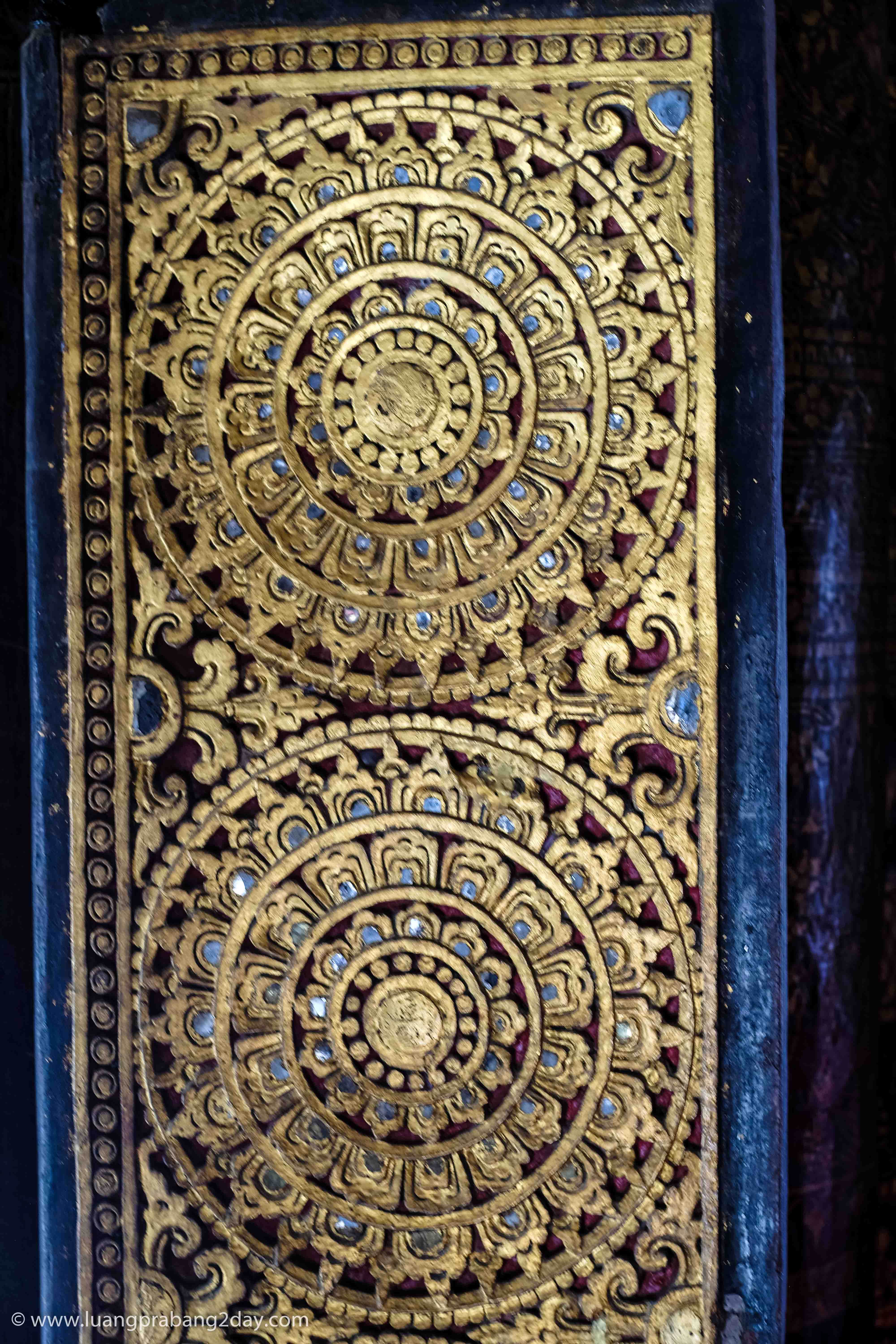 Close-up of an intricately carved gilded wooden panel inside Wat Xieng Thong. Close-up of an intricately carved gilded wooden panel inside Wat Xieng Thong.