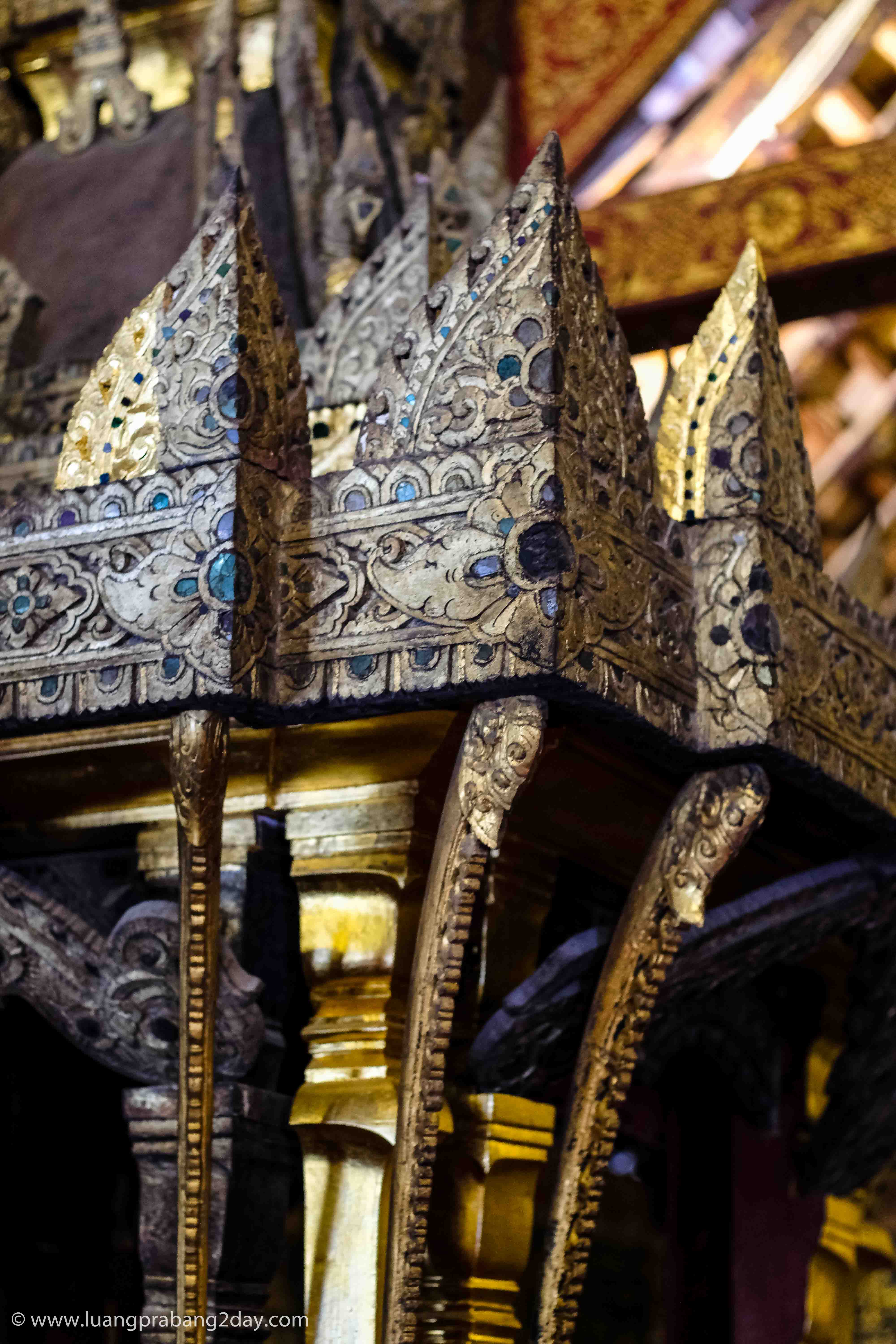 Intricately carved ceremonial structure decorated with gold leaf inside Wat Xieng Thong. Intricately carved ceremonial structure decorated with gold leaf inside Wat Xieng Thong.