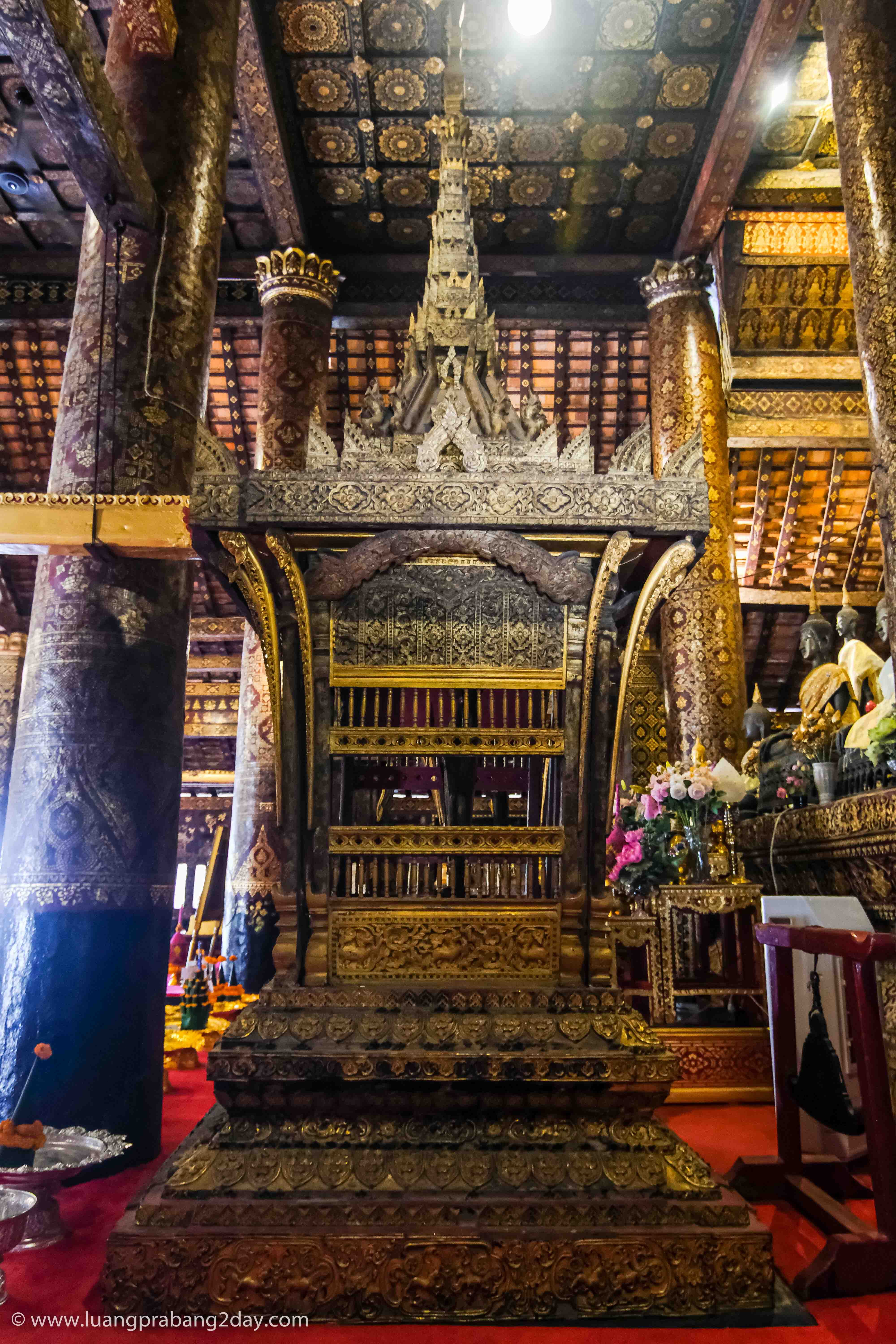 Ceremonial shrine inside Wat Xieng Thong reflecting traditional Lao Buddhist craftsmanship. Ceremonial shrine inside Wat Xieng Thong reflecting traditional Lao Buddhist craftsmanship.