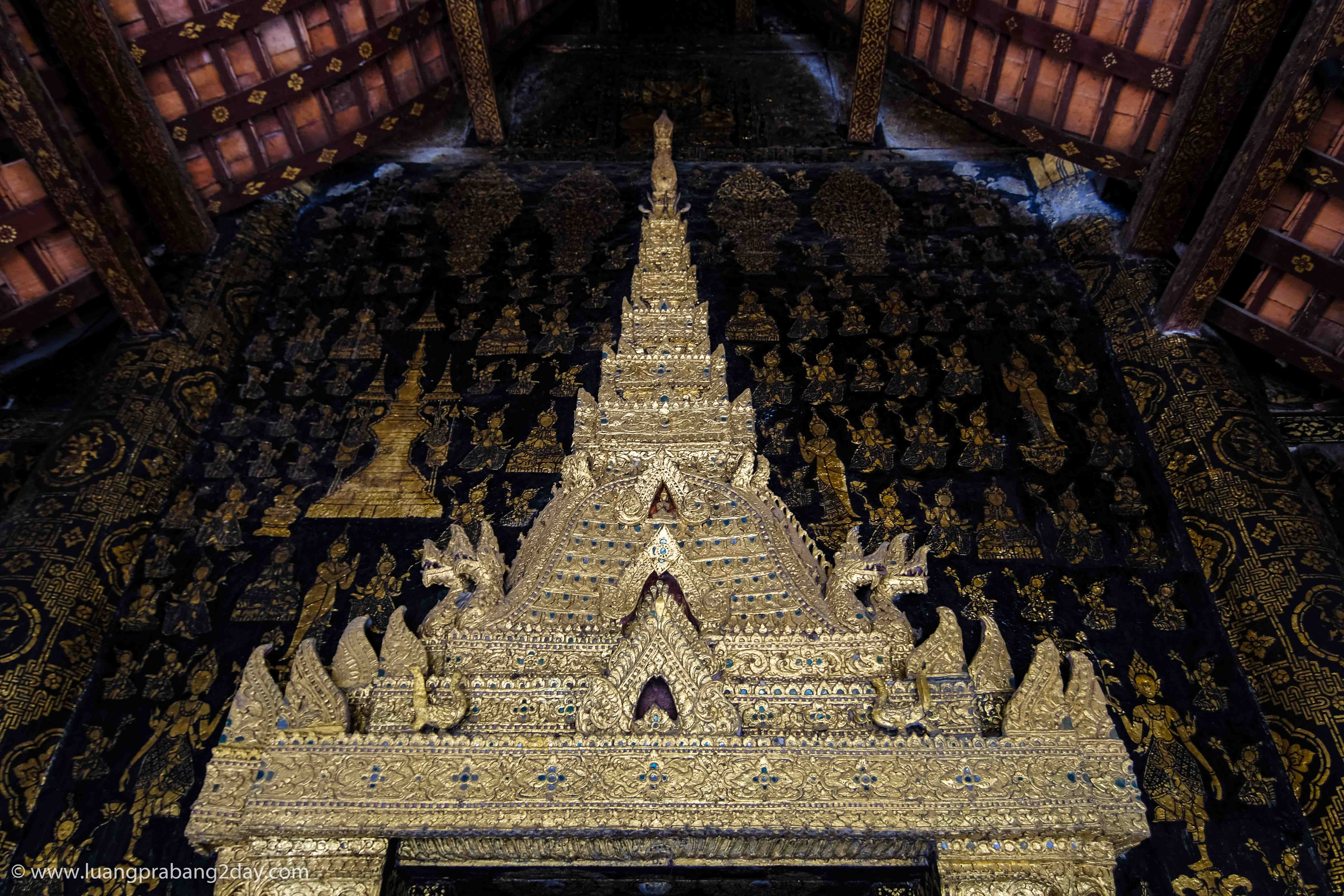 Decorated doorway leading toward the principal Buddha image inside Wat Xieng Thong. Decorated doorway leading toward the principal Buddha image inside Wat Xieng Thong.