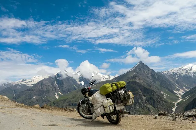 Ladakh mountain road with an adventure motorcycle and Himalayan landscape