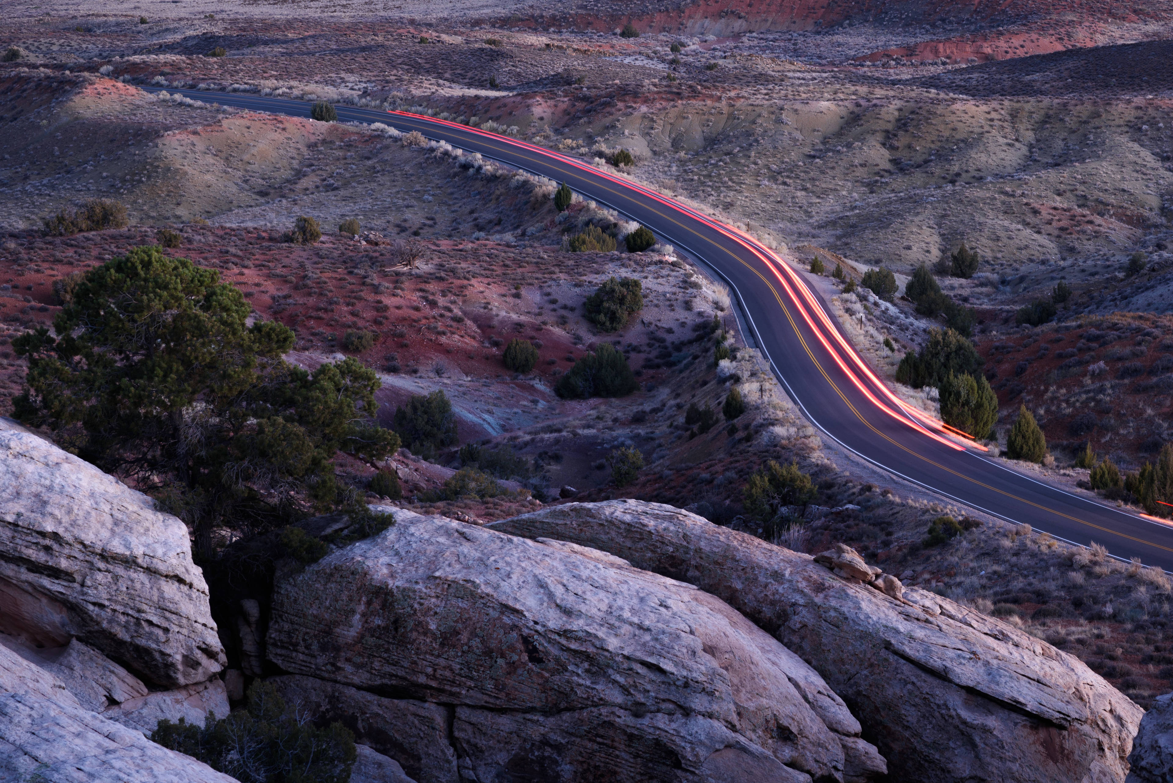 Utah road at sunset with travelling cars