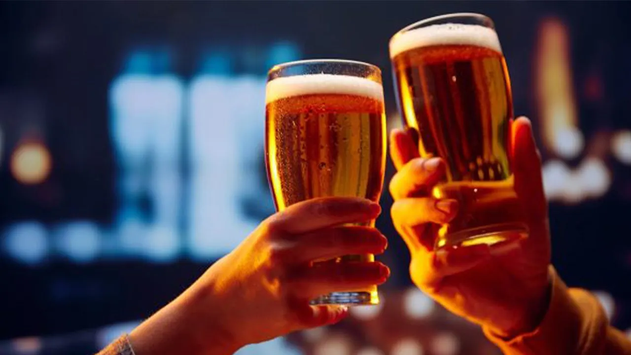 High quality image of people toasting with beer glasses, symbolizing team celebration or workplace camaraderie.