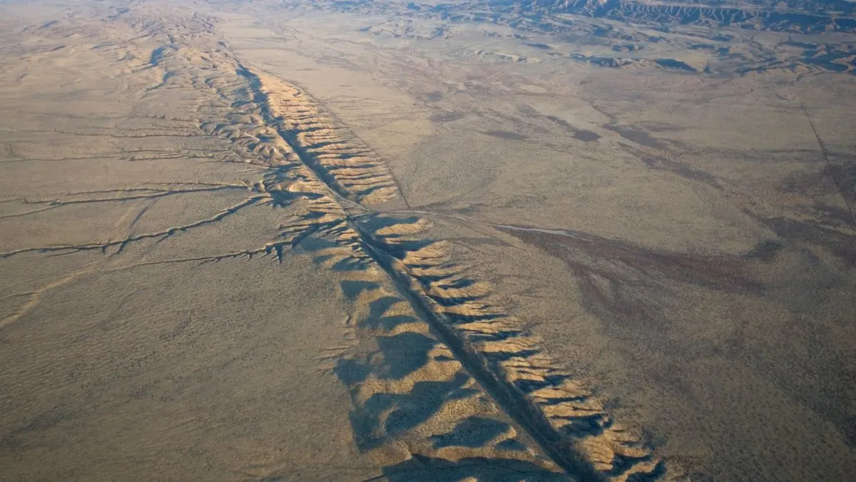 Aerial view of the tectonic plate boundary showcasing a landscape fractured by seismic activity, visualizing the dynamic nature of fault movement in San Andreas region.