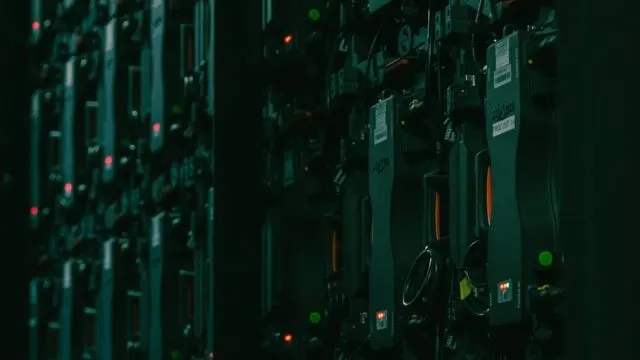 A stylized photo of a person in front of a screen with code and data, symbolizing digital privacy and data consolidation.