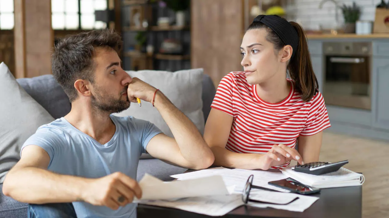 A thoughtful woman sits with a pensive look, symbolizing financial concern and mental stress—perfectly capturing the theme of economic anxiety.