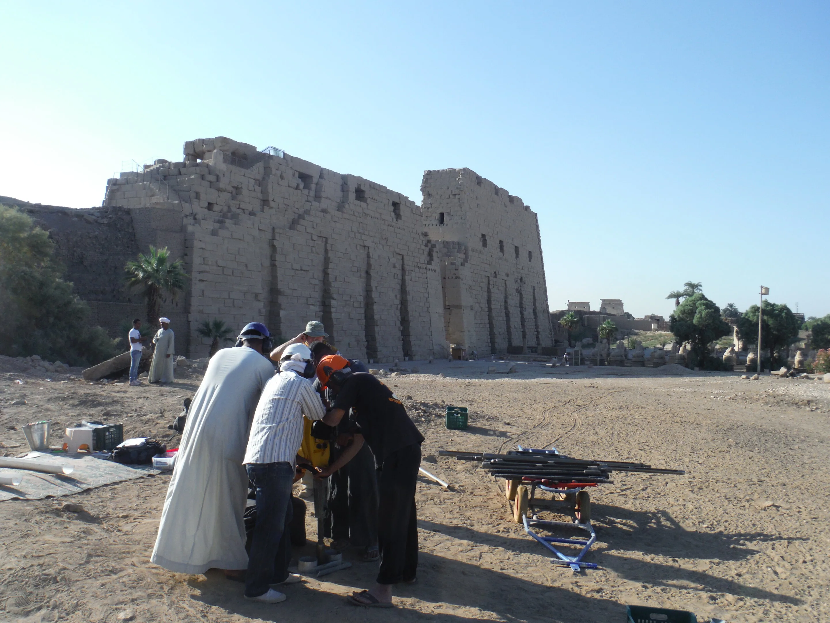 Archaeologists working at the Karnak Temple excavation site, revealing structures and artifacts buried for millennia.