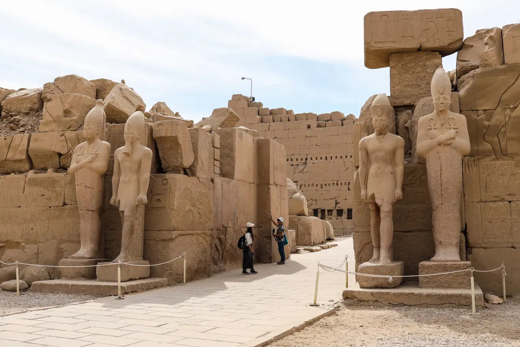 A panoramic view of the Karnak Temple complex, showcasing the grandeur of its ancient columns and sacred architecture under clear skies.