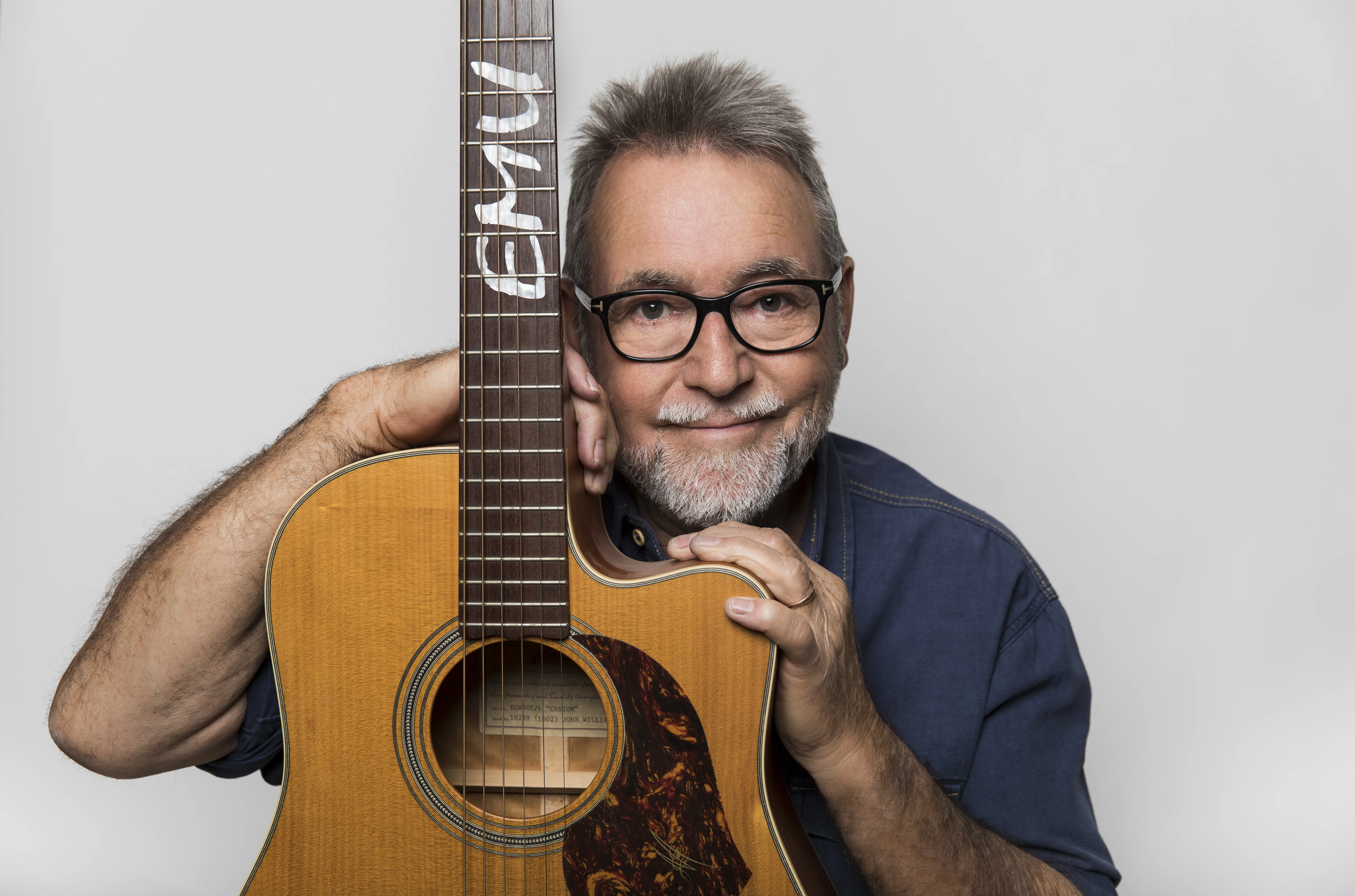 John Williamson, renowned Australian singer-songwriter, performing onstage - high quality and relevant to Australian national identity.