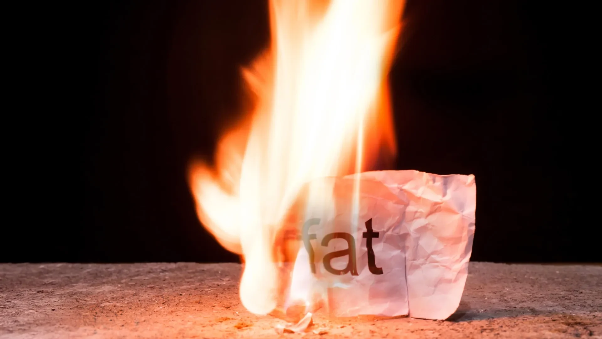 Creative conceptual image using crumpled paper to represent fat burning and loss, visually engaging and symbolic.