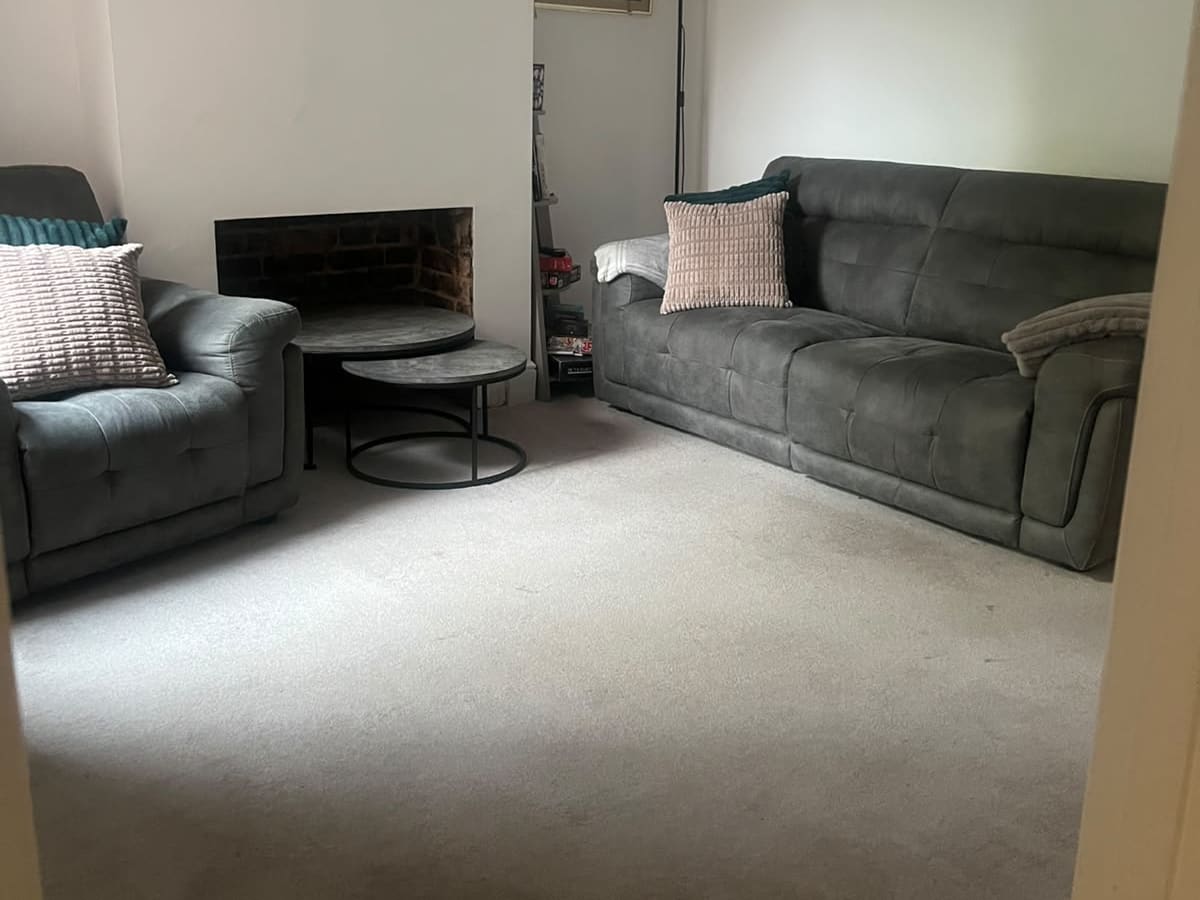 Clean living room with gray sofa and armchair